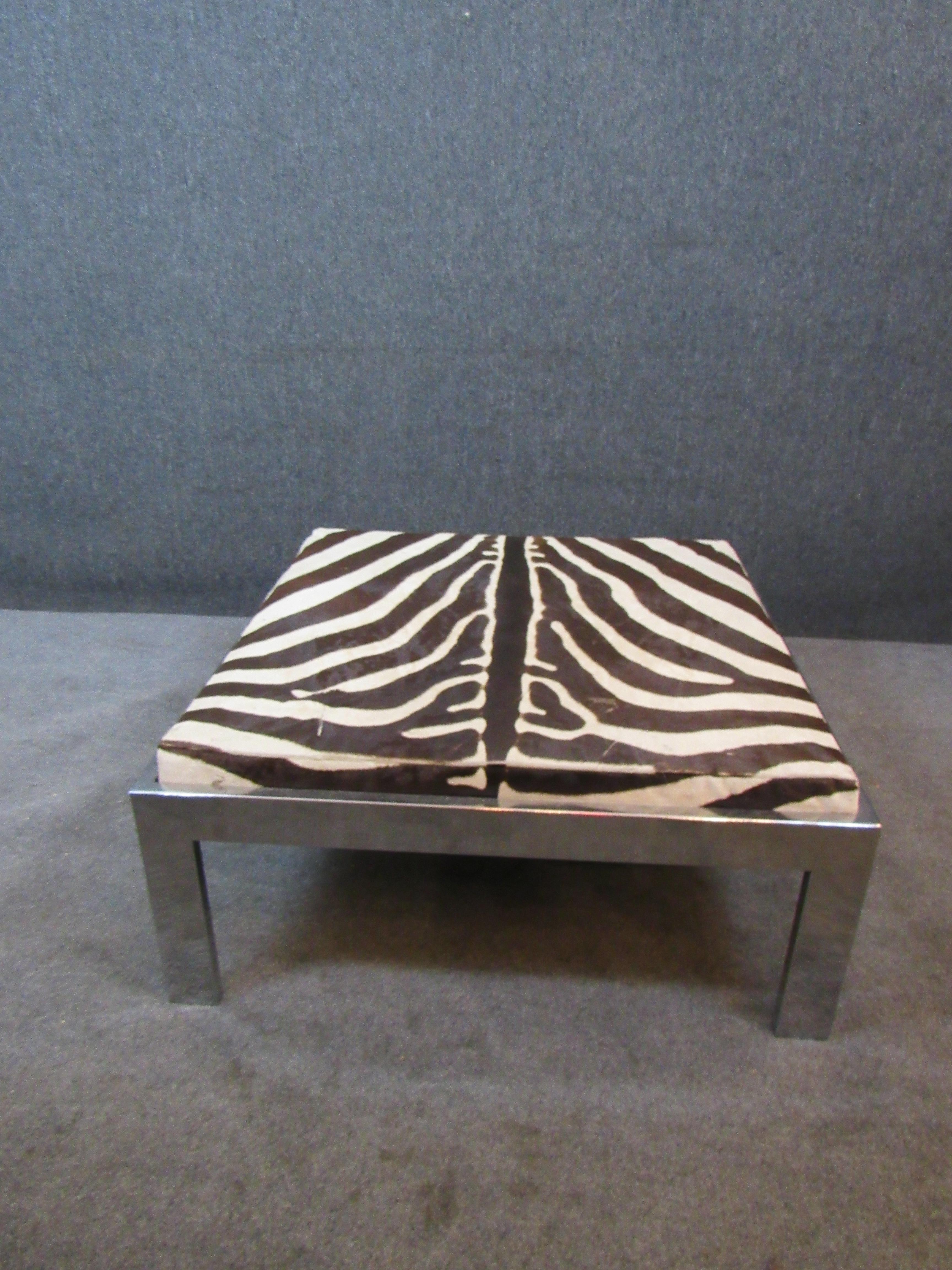 Kick back and sprawl out on this fantastically unique funky vintage jumbo zebra ottoman! With over 10 square feet of real hide upholstery, this piece truly brings home the excitement of the safari into the comfort of your living room! A shiny and