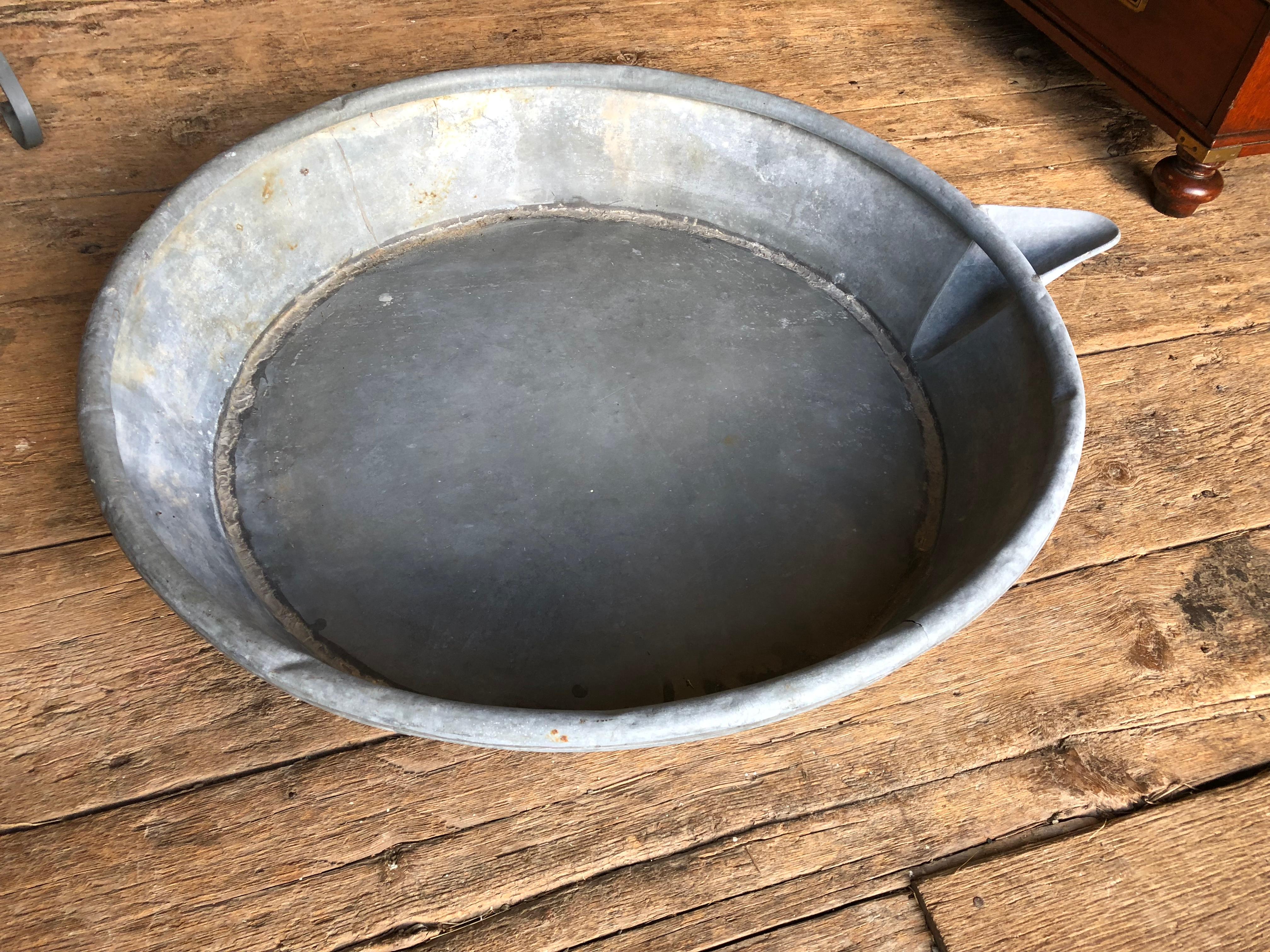 A large zinc pan, originally used to separate milk from cream, English 19th century, now perfect for use as a pan for an outdoor shower or planter.