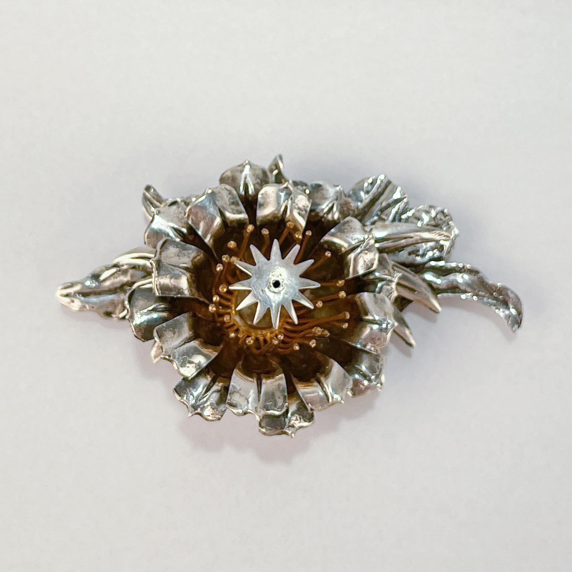 A very fine large, Hawaiian sterling silver brooch.

Made in Mexico for Floy Mercer.

With layered tropical sterling silver flower petals set on a figural leaf base.

Simply a great piece of Hawaiiana!

Date:
20th Century

Overall Condition:
It is