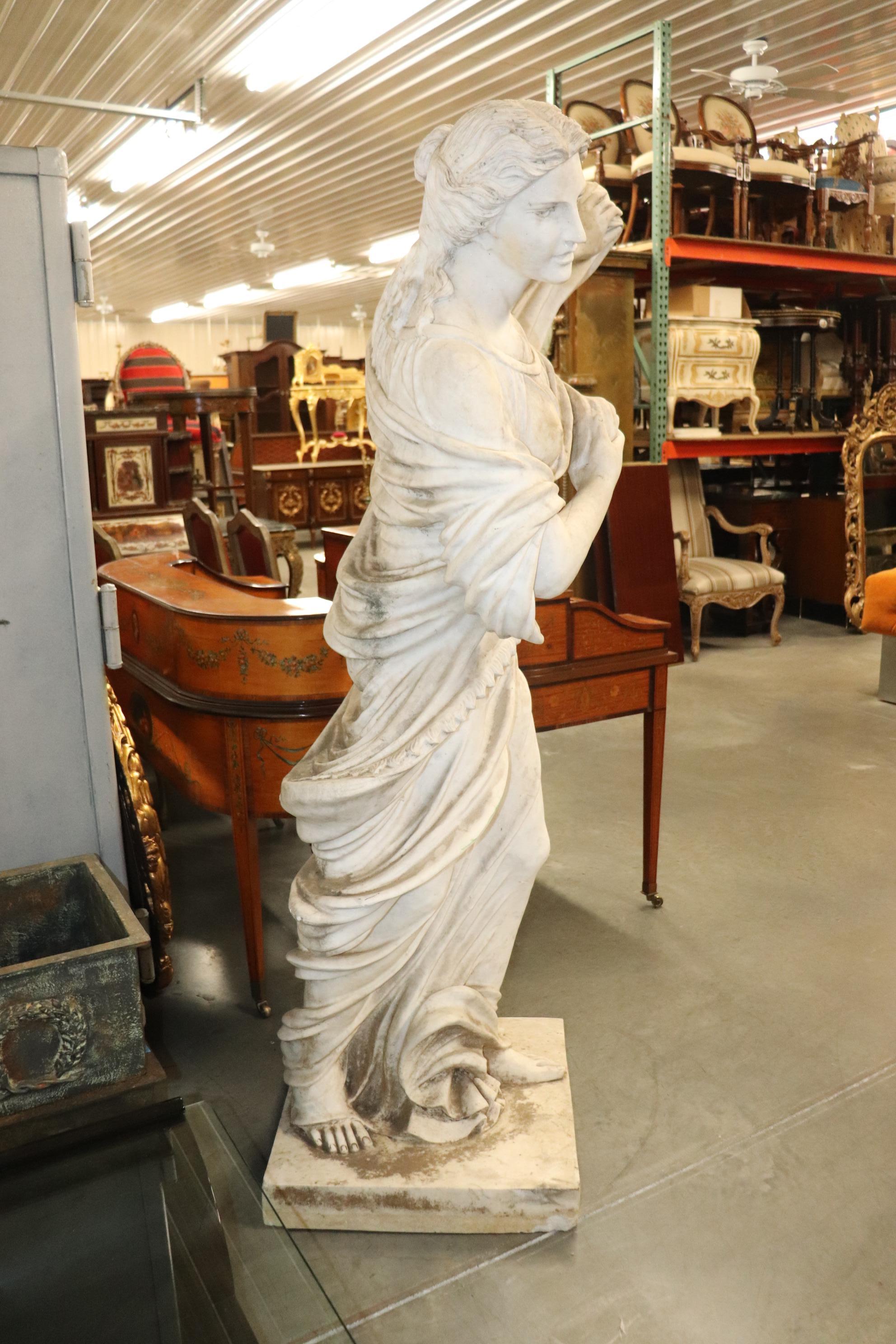 This is a superbly crafted Victorian era Italian made statue of carara marble of a maiden with her dress being blown by the wind. The feeling of movement and the carving is of the highest quality. Look at the toes and fingers, and the beautiful