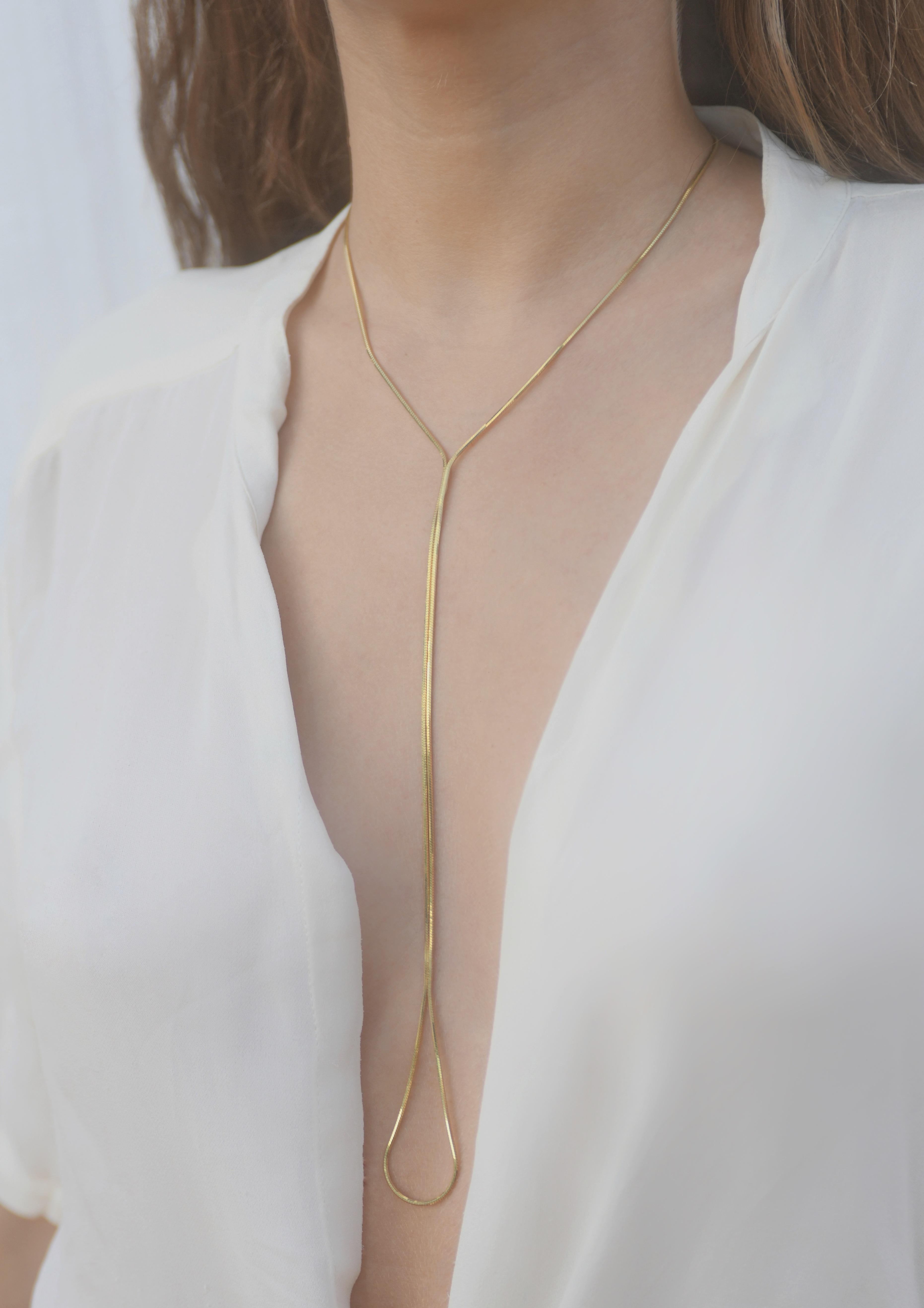 Playland  Lariat 

Created to compliment and caress a woman's neckline. Through the use of the snake chain, this gold plated silver lariat creates movement and adds an extra glow to your look. Hand-crafted by local skilled Greek craftsmen.

This