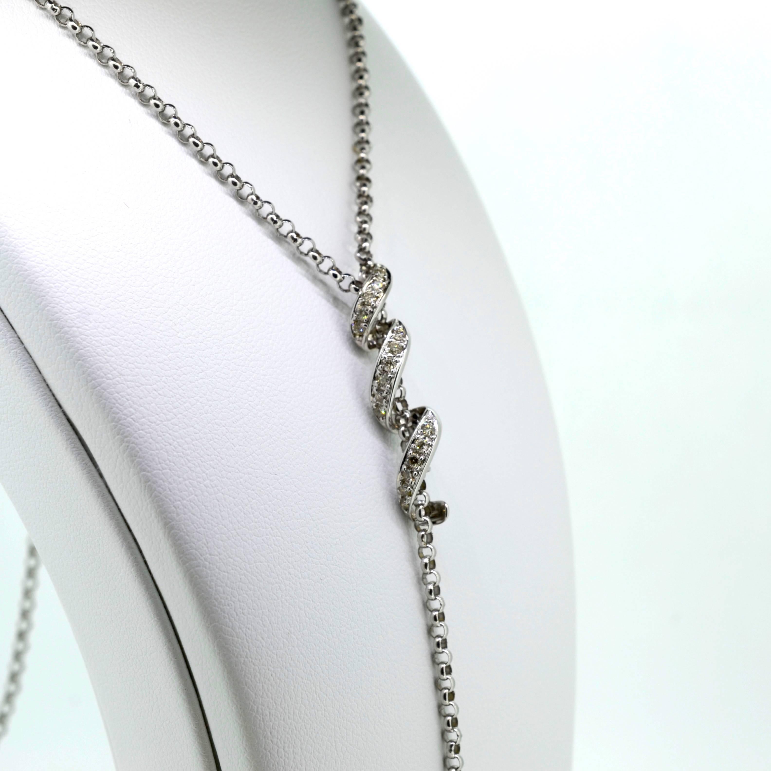 Graceful lariat;  14 kt white gold slide with adjustable length.  The slide is a white gold loose spiral pave set with diamonds.    
.41 ct. TW full cut    VS clarity   color
A one inch bar dangles from the bottom of the chain.  Great with a V-neck
