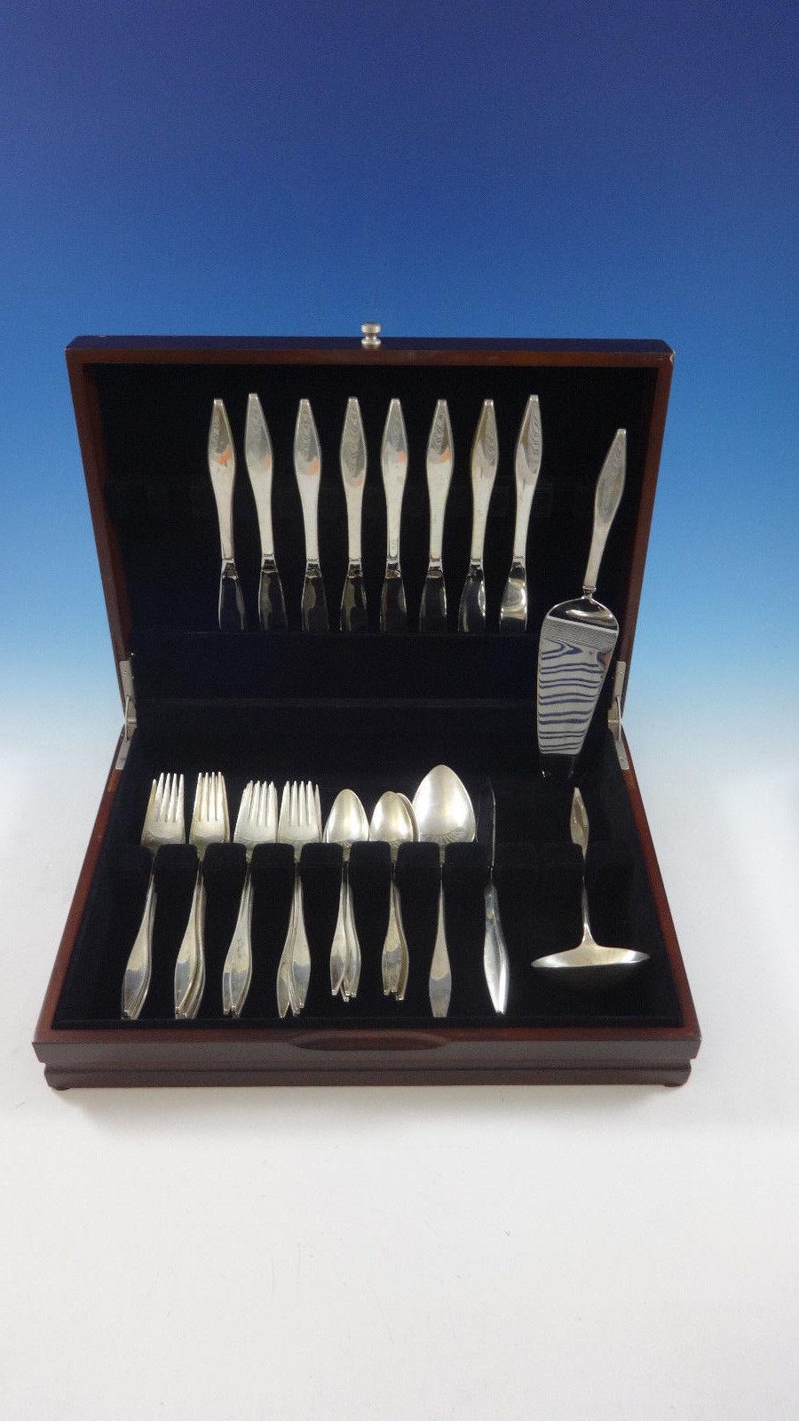 Mid-Century Modern Lark by Reed & Barton sterling silver Flatware set - 36 Pieces. Designed by John Prip. This set includes:

8 knives, 9