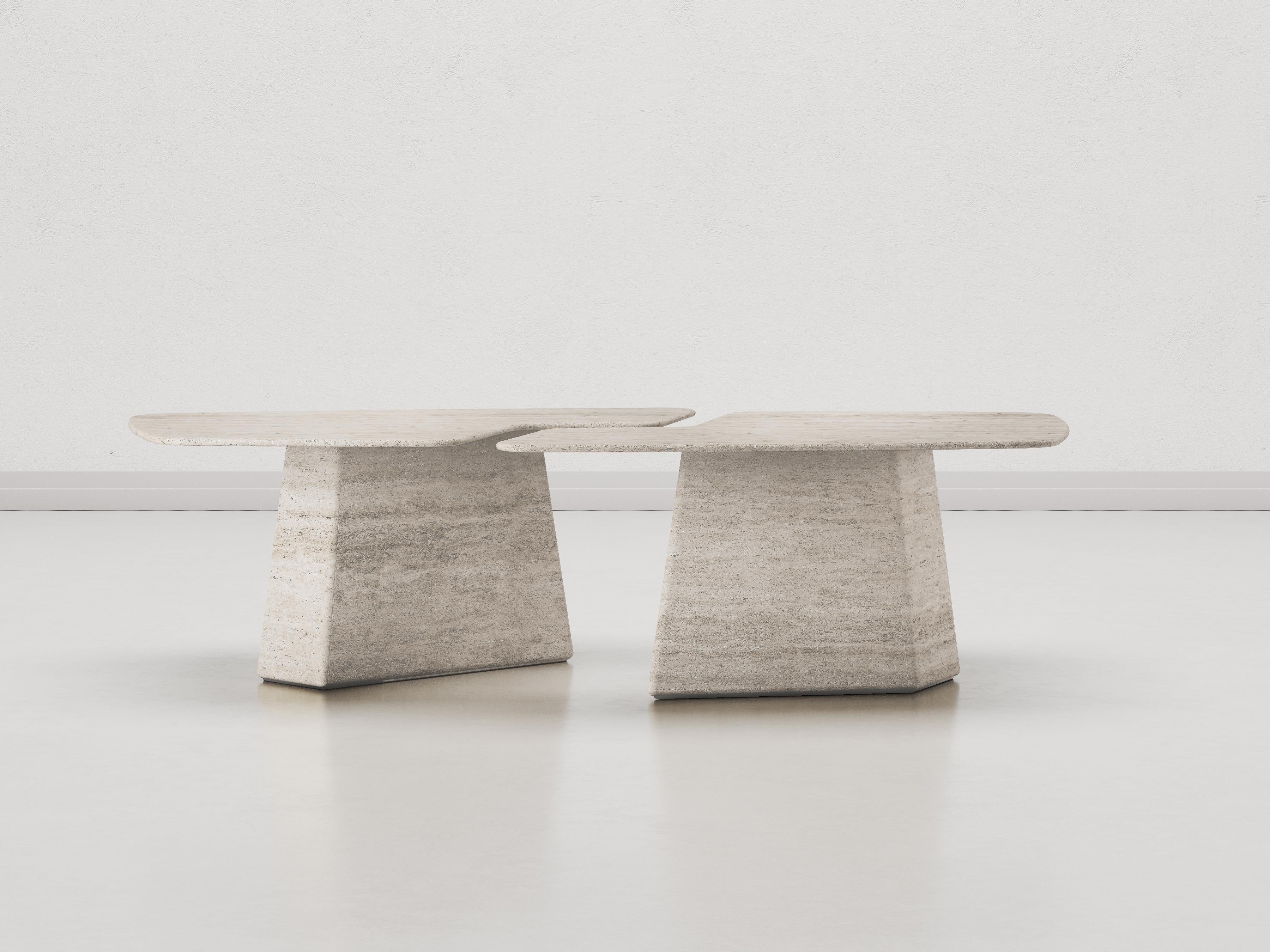 L’Armando dining table is an exquisite symphony of design and craftsmanship. Comprising two intertwining marble modules, this table boasts an organic, irregular silhouette with gracefully rounded edges. The surface is a canvas where the matter