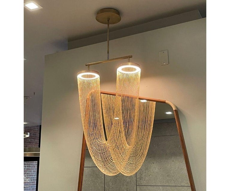 It is with a poetic beauty captured in this luxurious high-end lighting fixture that has been coated with warmth and elegance, that it will infect your daily life. This sculptural light is hand-crafted with delicate copper chains to create a unique