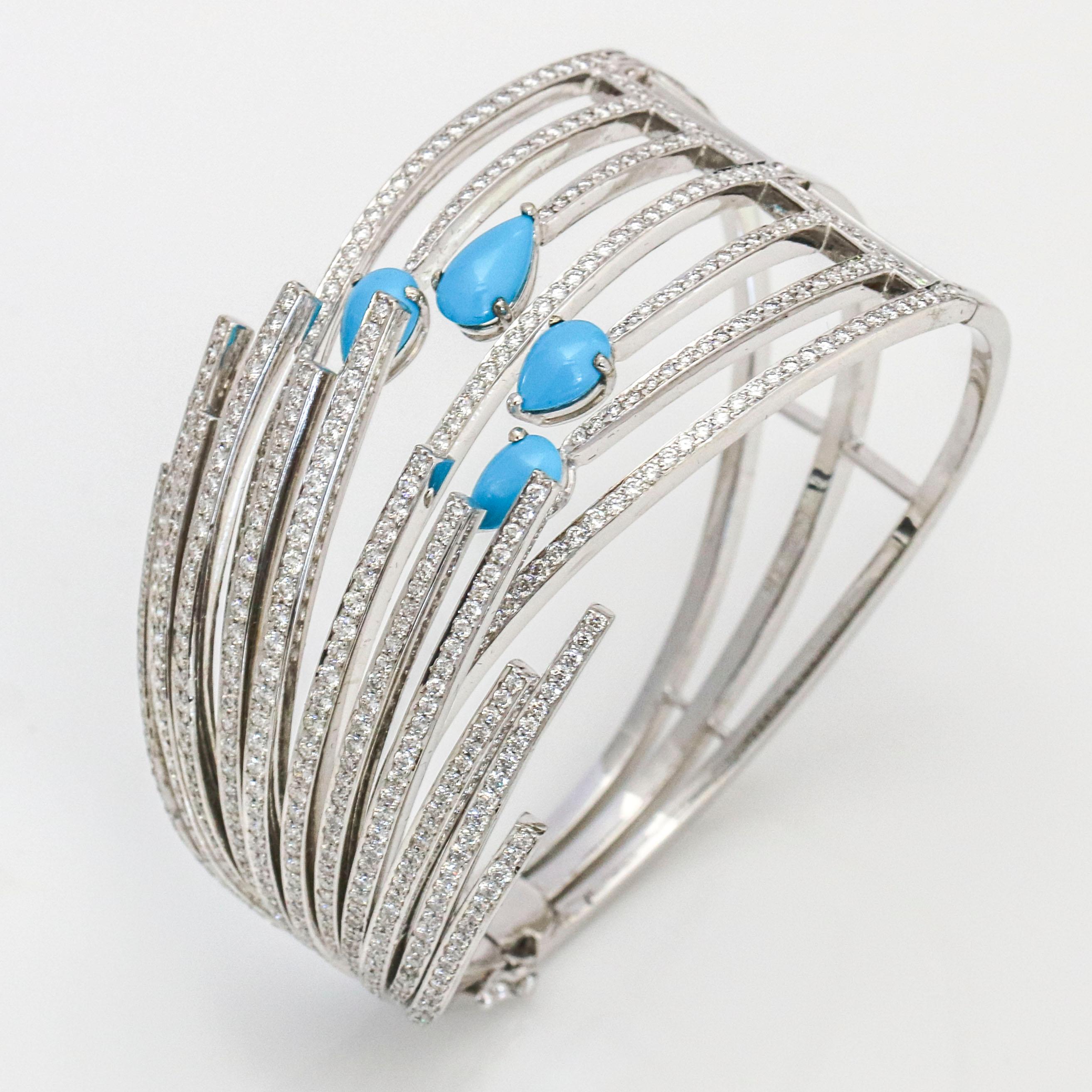 Wide bangle bracelet in 18-karat white gold with diamonds and turquoise. The bracelet has 70 round-cut natural diamonds and 4 pear cabochon sleeping beauty turquoise. Signed LARRY.

Size, Small (fits a wrist up to 5.75 inches)
Width, 36 mm - 7