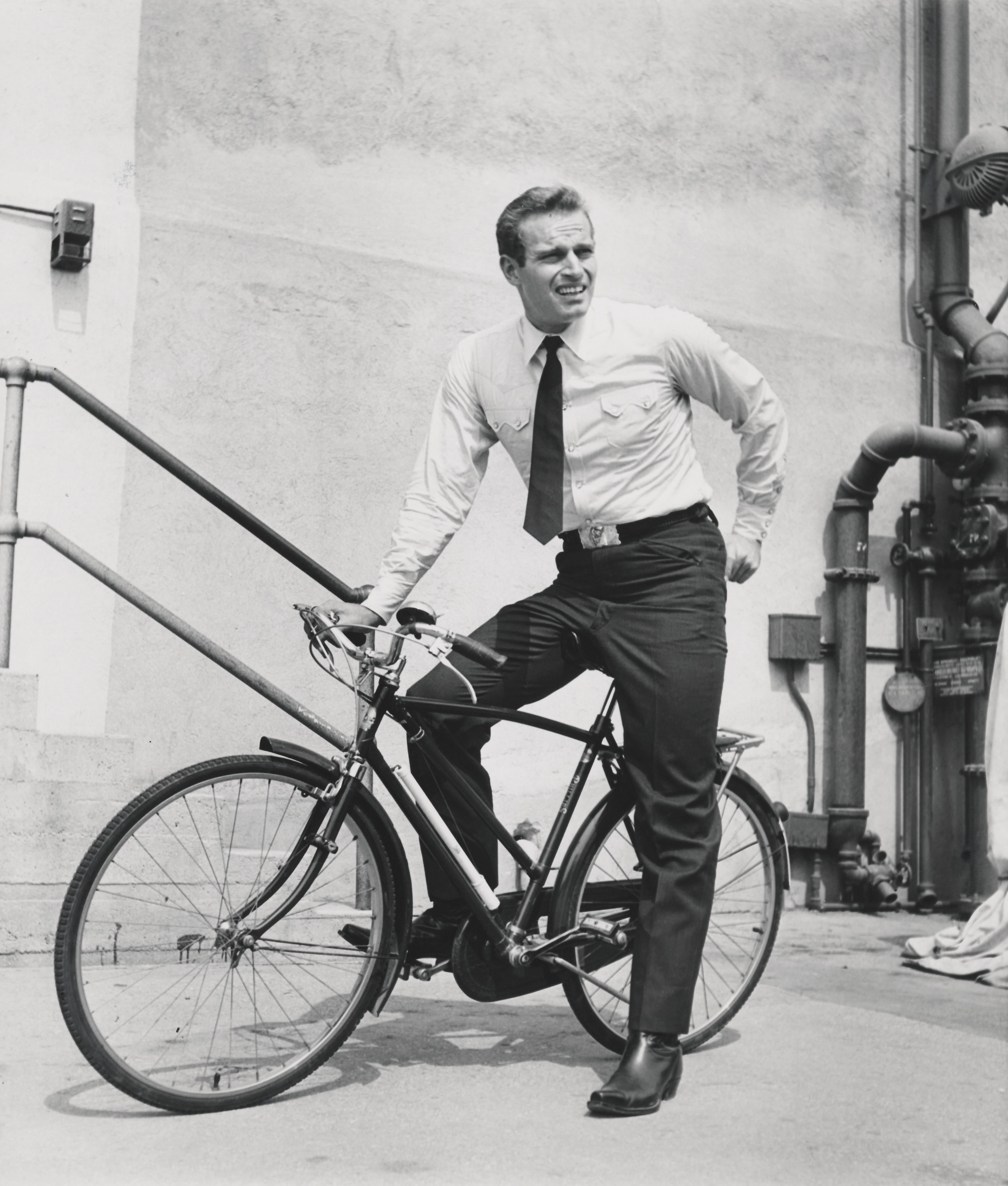 Larry Barbier Portrait Photograph - Charlton Heston Riding Bike Fine Art Print