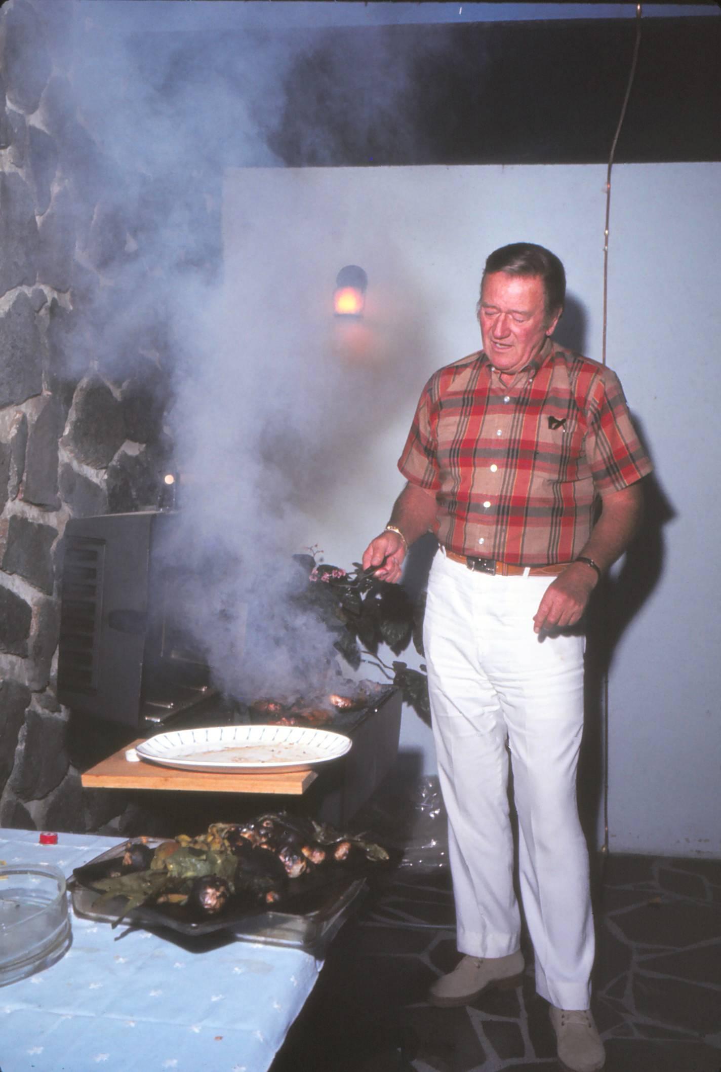 Larry Barbier Portrait Photograph - John Wayne Cooking on Grill Fine Art Print