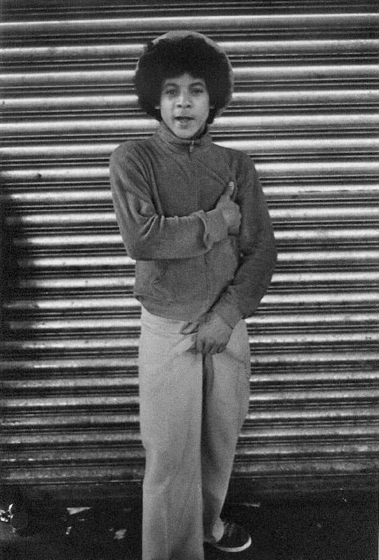 Untitled (Hustler in Front of Gate)