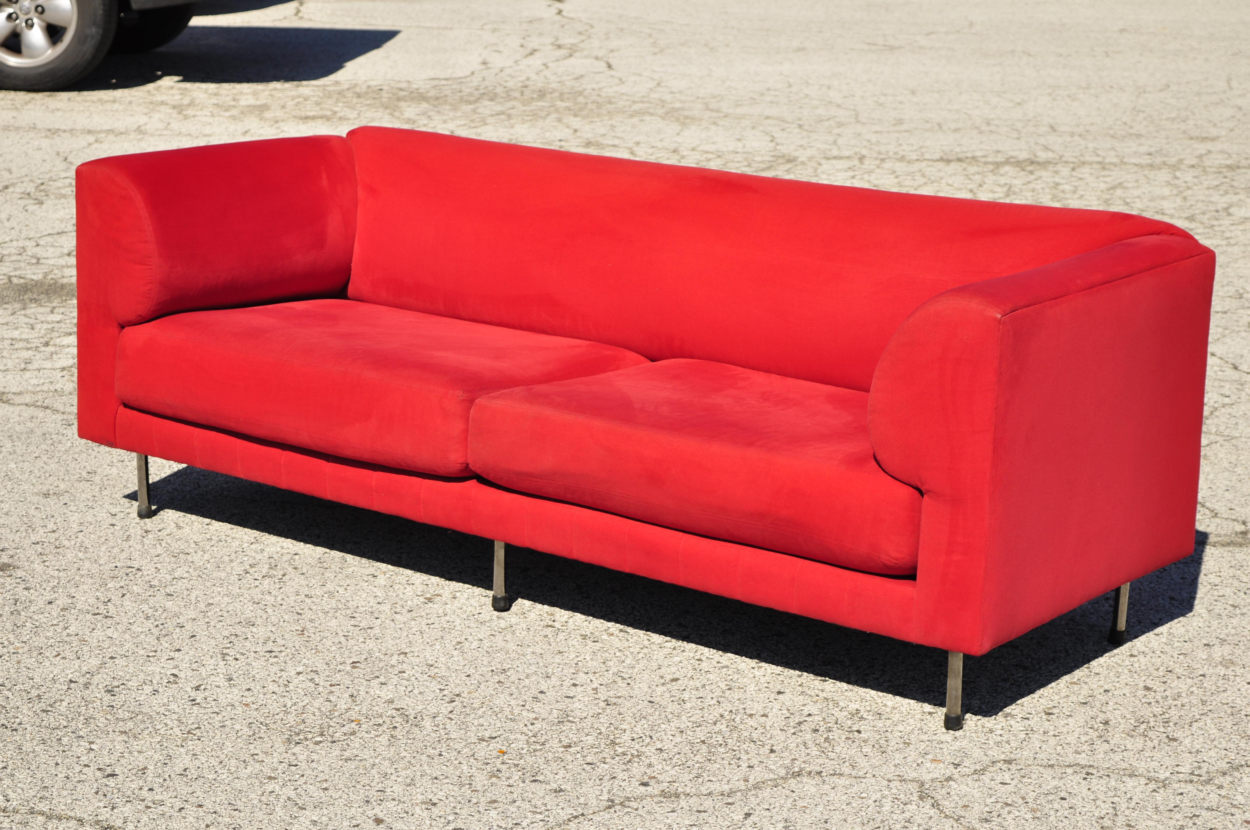 Larry Laslo for Directional red modern Italian Bauhaus style chrome leg sofa. Listing includes 6 chrome metal legs, red microfiber upholstery, original label, clean modernist lines, sleek sculptural form, circa late 20th century. Measurements: 32