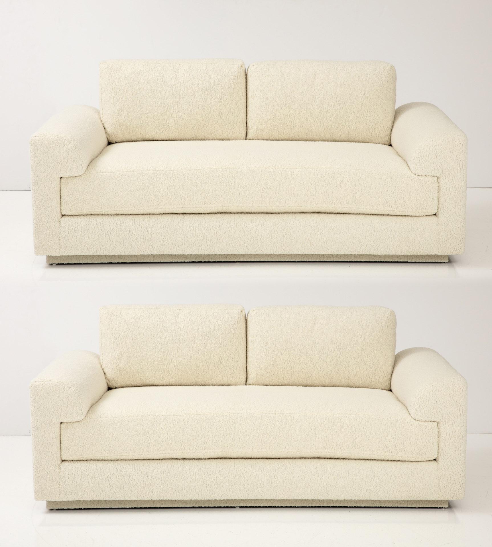 Modernist sofa designed by Larry Laslo for Directional featuring new Italian Ivory Boucle fabric. Back and seat feature cushions which are foam wrapped down and are extremely comfortable yet supportive. 2 throw pillows included. Currently 2 sofas