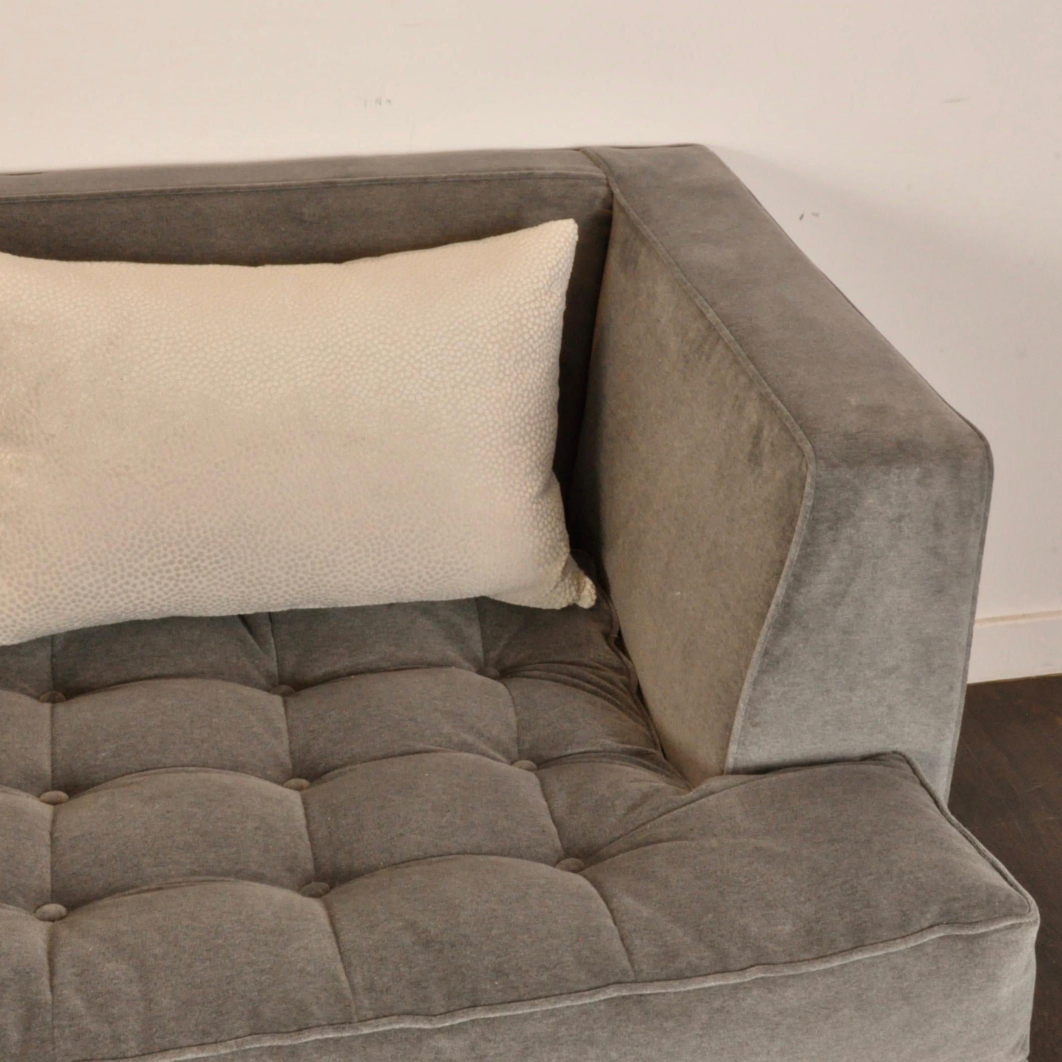 This sofa is solidly built by Directional, one of the premier furniture makers in the country. It has been newly recovered in a medium grey velvet. Designed by Larry Laslo, who has worked as an interior designer illustrator, visual merchandiser, art