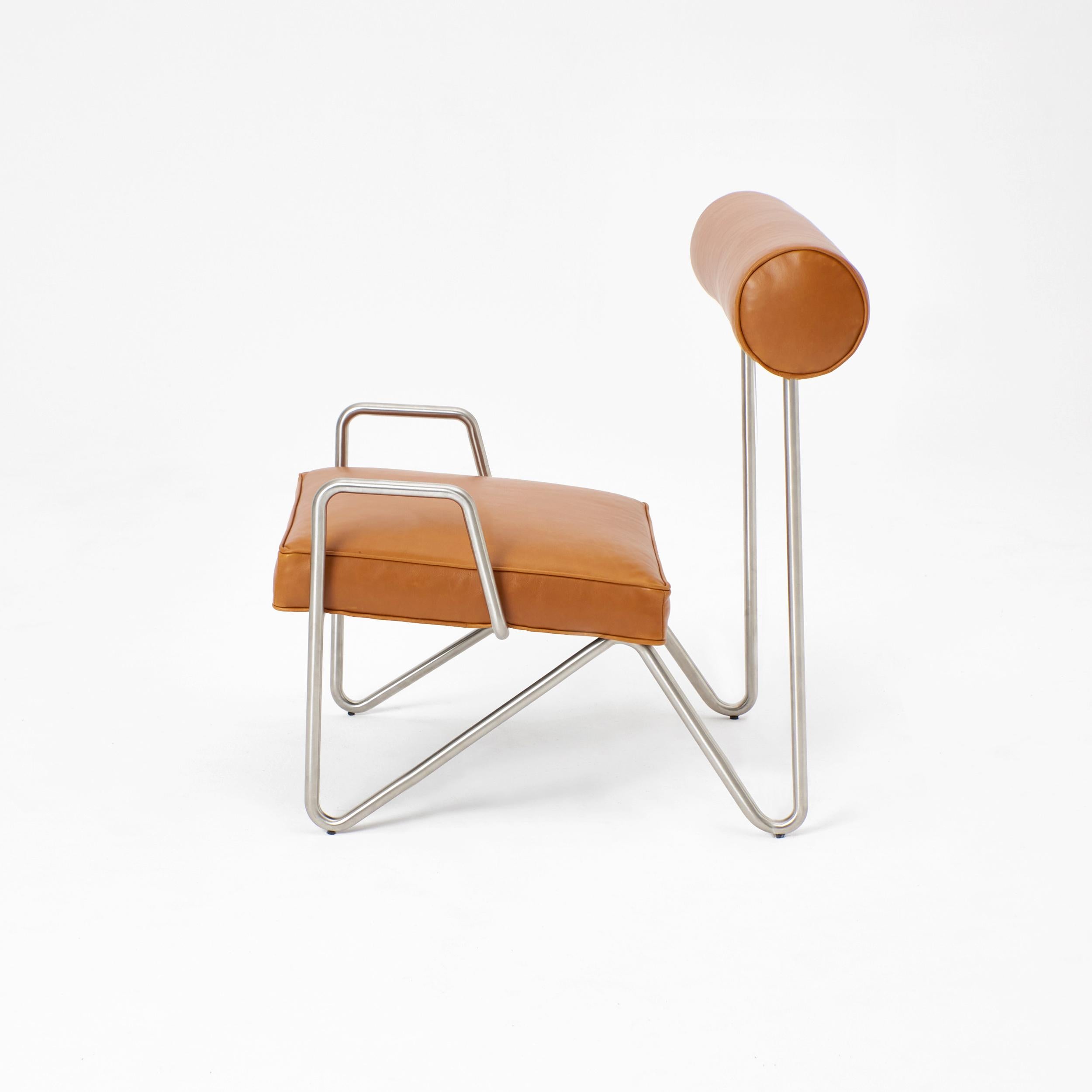 Larry's Lounge chair in Tan leather, designed by project 213A in 2022

The frame is engineered by shaping a single metal rod to yield an elegant, minimalistic design. Combined with rich sustainable leather of the seat and the backrest. The lounge