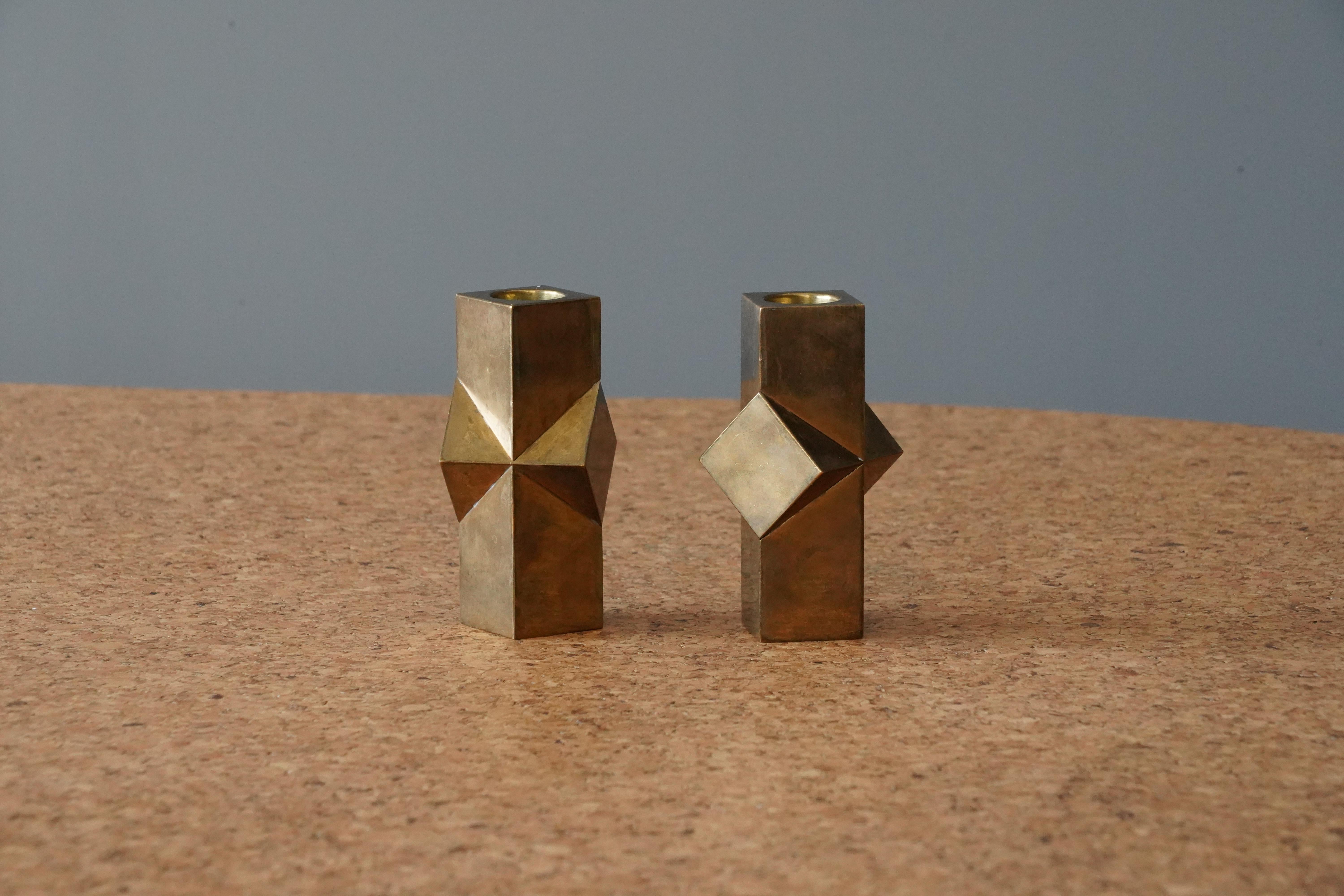 A pair of small candlesticks. In brass, heavy alloy. Designed by Lars Åkesson. This pair signed and dated 1982.

  