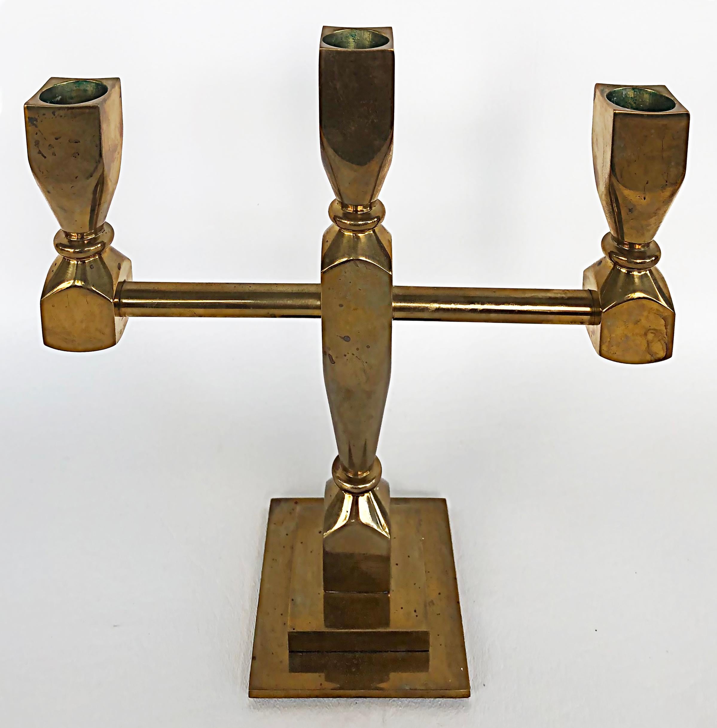 Lars Bergsten Gusum Metallslöjden brass candelabra, Sweden 1983

 Offered for sale is a 1983 Swedish mid-century Gusums Bruk candelabra designed by Lars Bergsten. The brass candelabra holds 3 candles and is marked as well as dated 1983 underneath