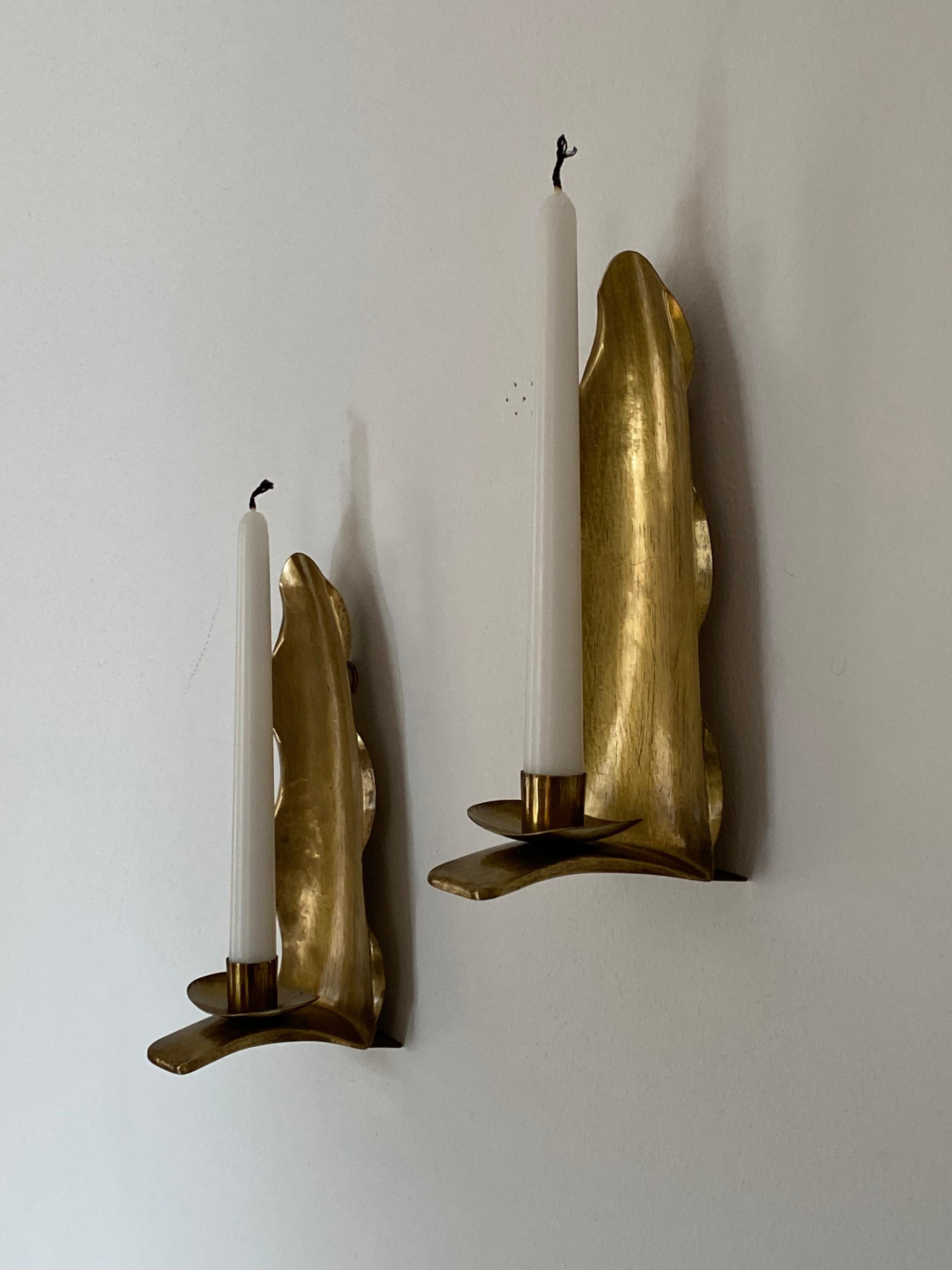 A pair of candle sconces / wall candle holders, design and production attributed to Lars Holmström, Sweden, 1940s. In brass.

Other designers of the period include Piet Hein, Paavo Tynell, Josef Frank, and Jean Royère.
 
    