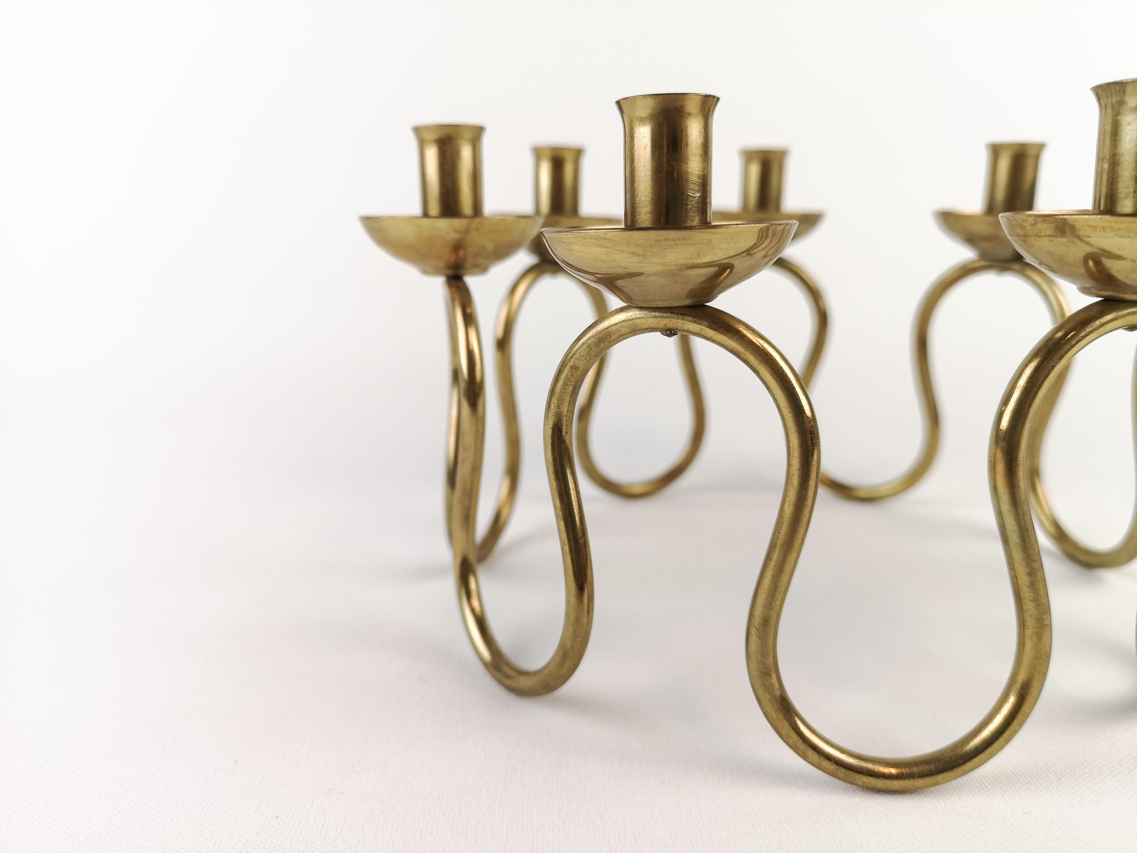 Brass candlestick designed by Lars Holmström. Produced by Lars Holmström in Arvika, Sweden.

Signs of ware and use.