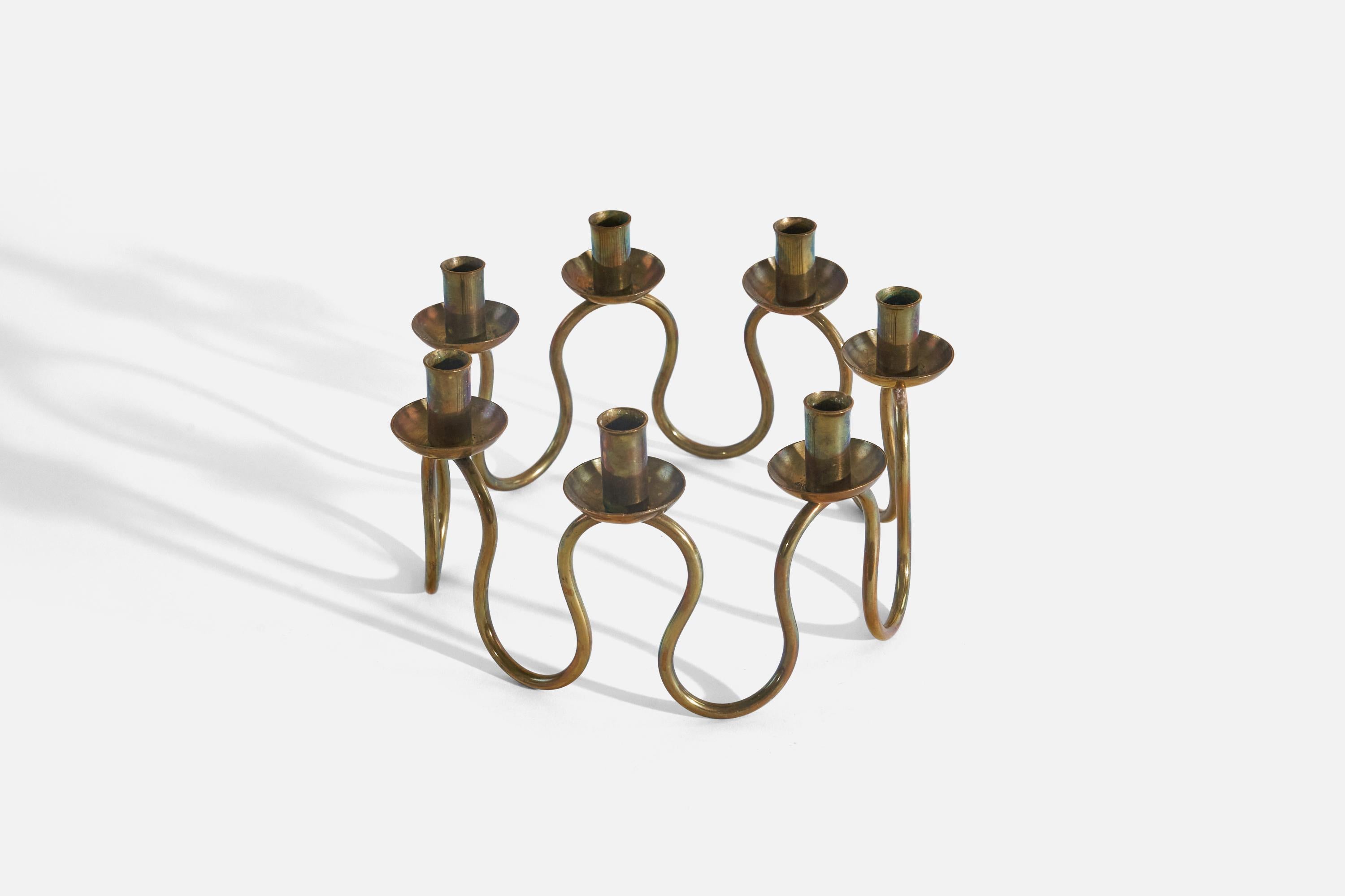 A brass candelabra designed by Lars Holmström and produced by Svenskt Tenn, Sweden, 1950s. 