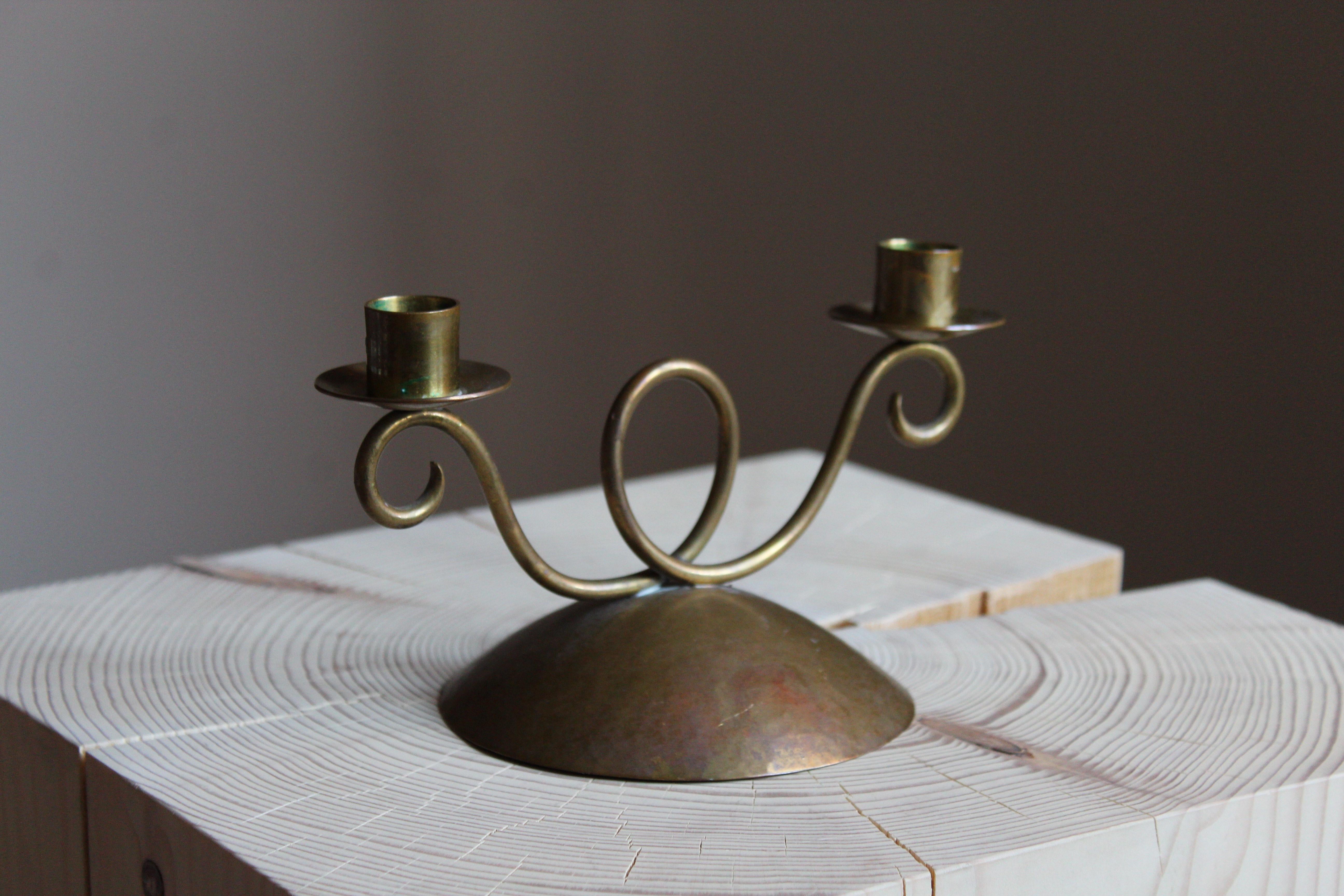 A small candelabrum or candleholder, design and production attributed to Lars Holmström, Sweden, 1940s. In brass.

Other designers of the period include Piet Hein, Paavo Tynell, Josef Frank, and Jean Royère.
 
  