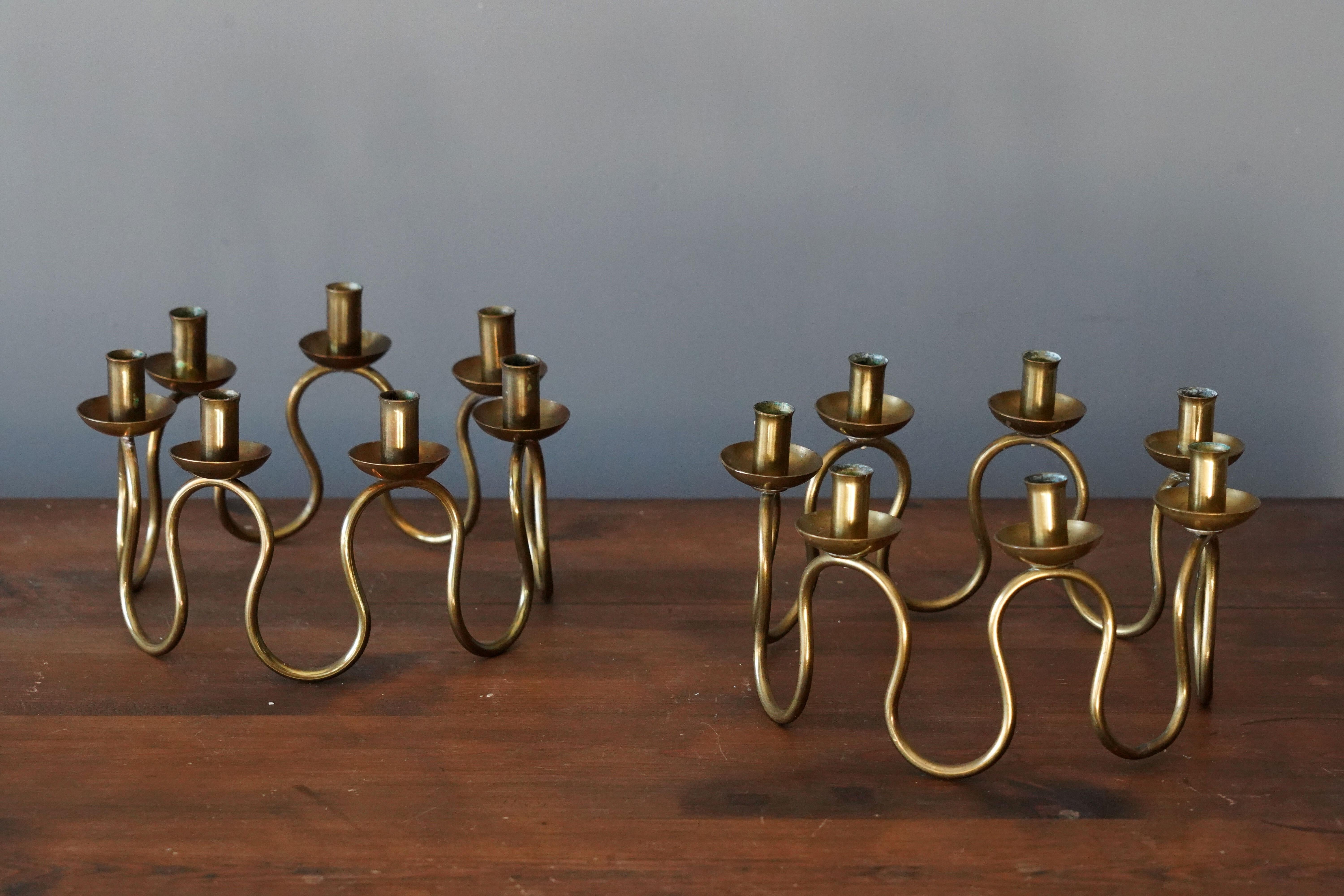A pair of organic candelabras, designed by Lars Holmström for Svenskt Tenn, Sweden, 1950s. In brass.

Other designers of the period include Piet Hein, Paavo Tynell, Josef Frank, and Jean Royere.

 