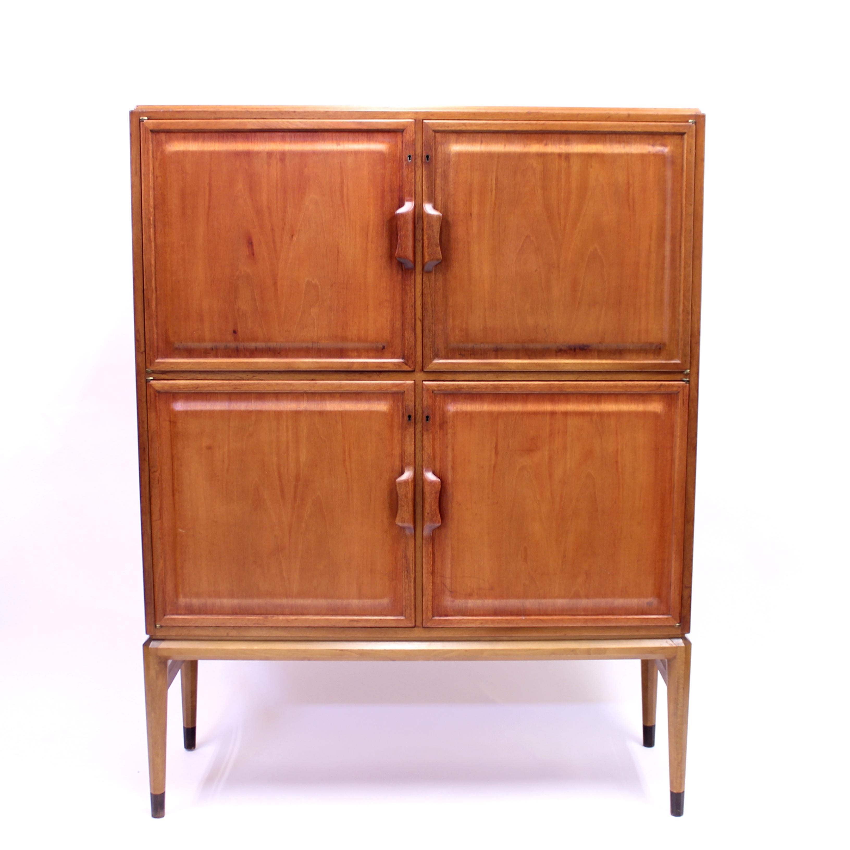 Four door cabinet, model 2910, in mahogany designed in 1949 by Axel Larsson or Bertil Fridhagen for SMF (Svenska Möbelfabrikerna) Bodafors. Both of these designer were working for Bodafors at the time and it is up to this day not really clear who