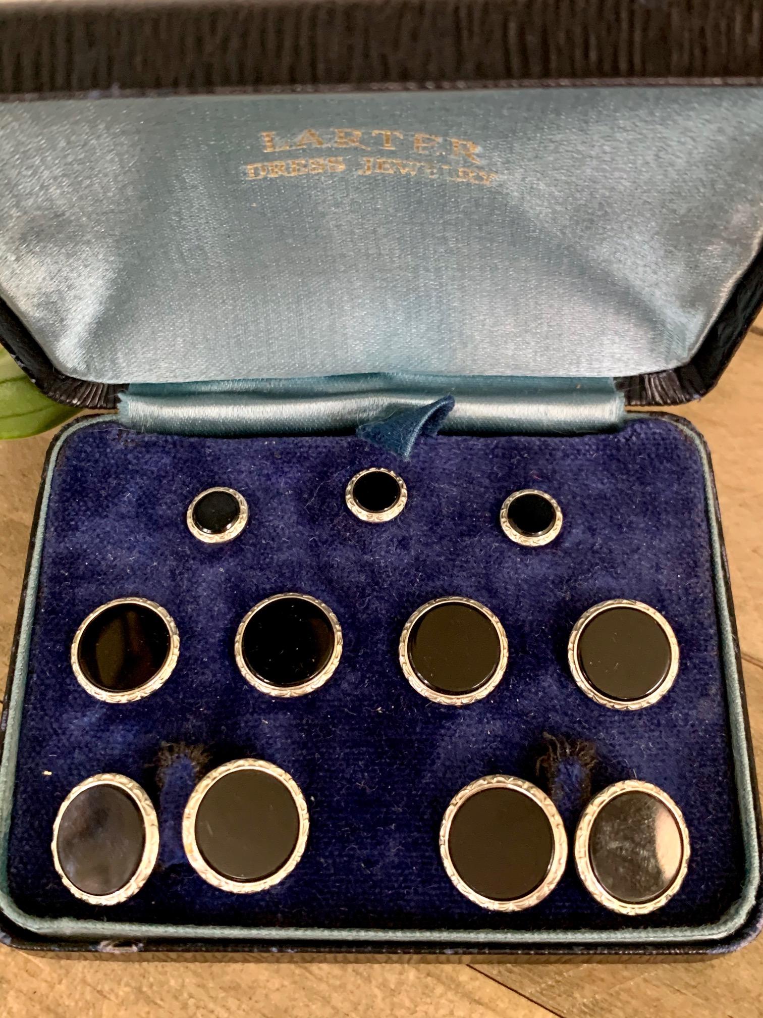 This very handsome Larter & Sons Art Deco cufflinks and stud set have a center stone of black onyx, surrounded by a yellow and white gold setting.  It is a full nine piece set with all pieces in excellent condition.

They are stamped 