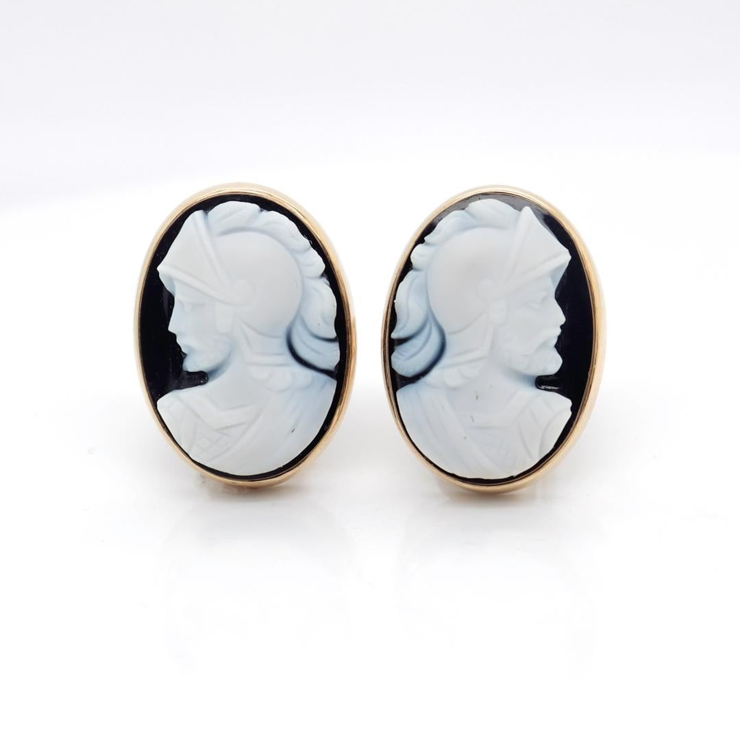 A fine pair of signed cameo cufflinks

By Larter & Sons of Newark, New Jersey.

In 14k gold and set with carved banded black & white agate cameo cabochons of Roman soldiers.

With pivoting bullet toggles.

Marked to the reverse with 14 and the