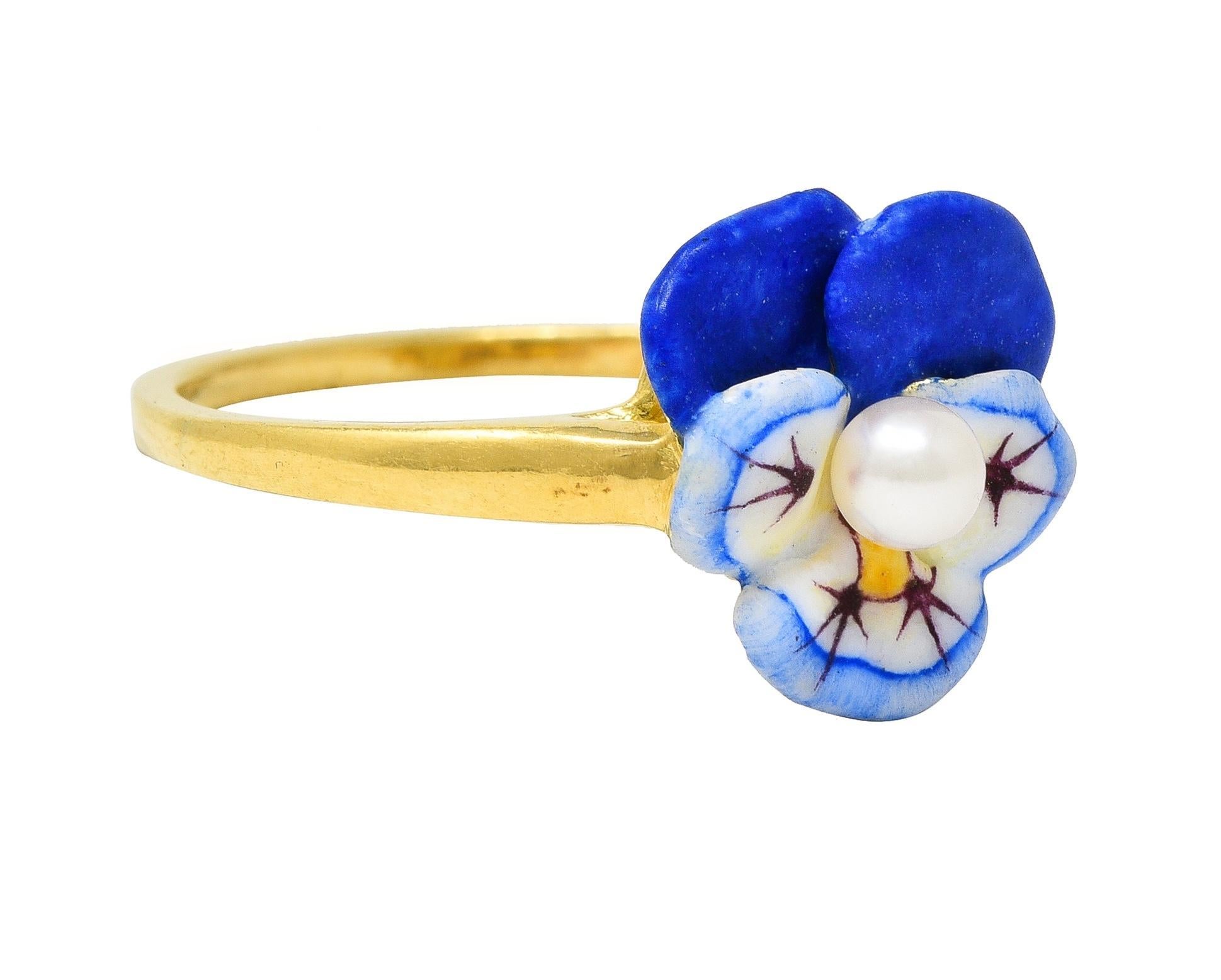 Designed as a dimensional pansy flower painted with opaque enamel 
White, blue, yellow, and maroon with minimal loss 
Centering a 3.0 mm round pearl-white with subtle iridescence
Completed by tapered yellow gold shank 
With high polish finish
