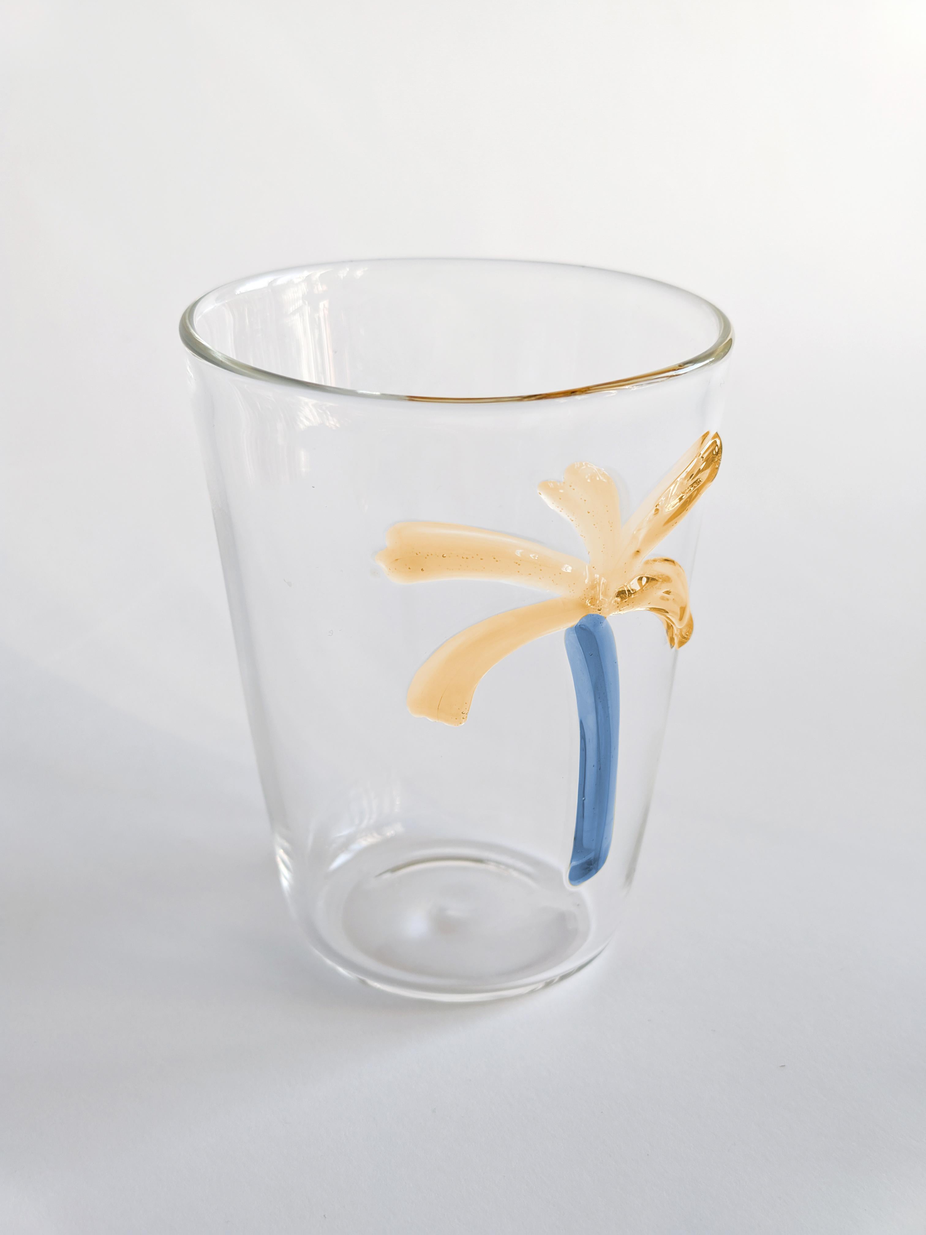 Las Palmas glasses are a collection of made in Italy blown glasses and a pitcher. Every piece is unique and embellished with palm inspired decoration.
Set of two water glasses.