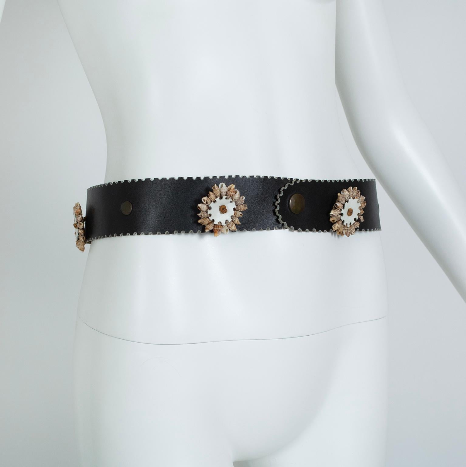 The perfect accompaniment to a breezy summer ensemble, this seashell motif belt adds a bit of bohemian whimsy to a bathing suit, pareo, kaftan or tunic. Just add sand.

Wide black-brown leather belt with laser cut castellated edges; 2” diameter