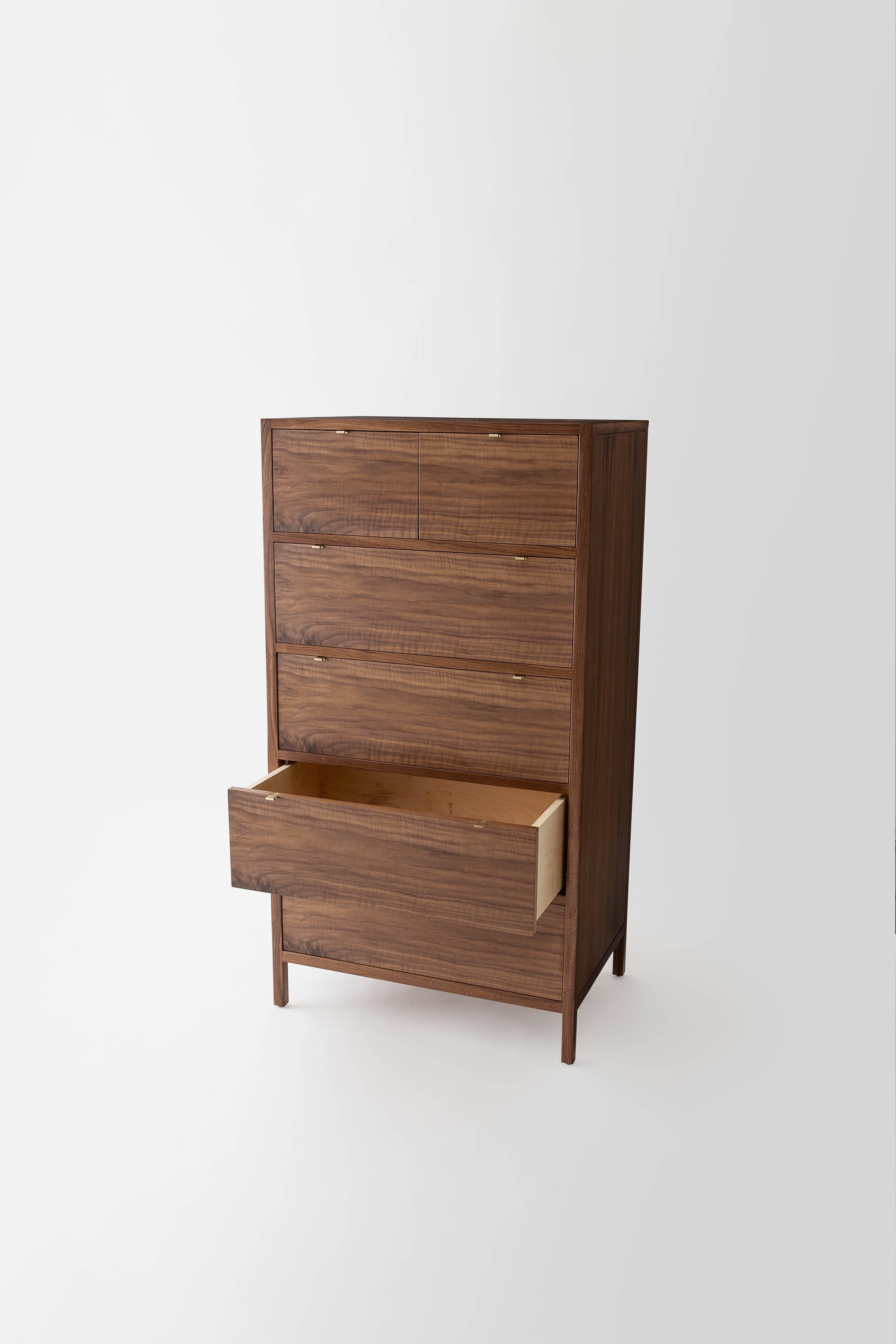 The Laska dresser is built in our Louisville, KY studio using premium hardwoods and thoughtfully selected wood veneers. This piece features custom veneered panels framed flush with solid hardwood edges and legs. Shown as a six drawer highboy