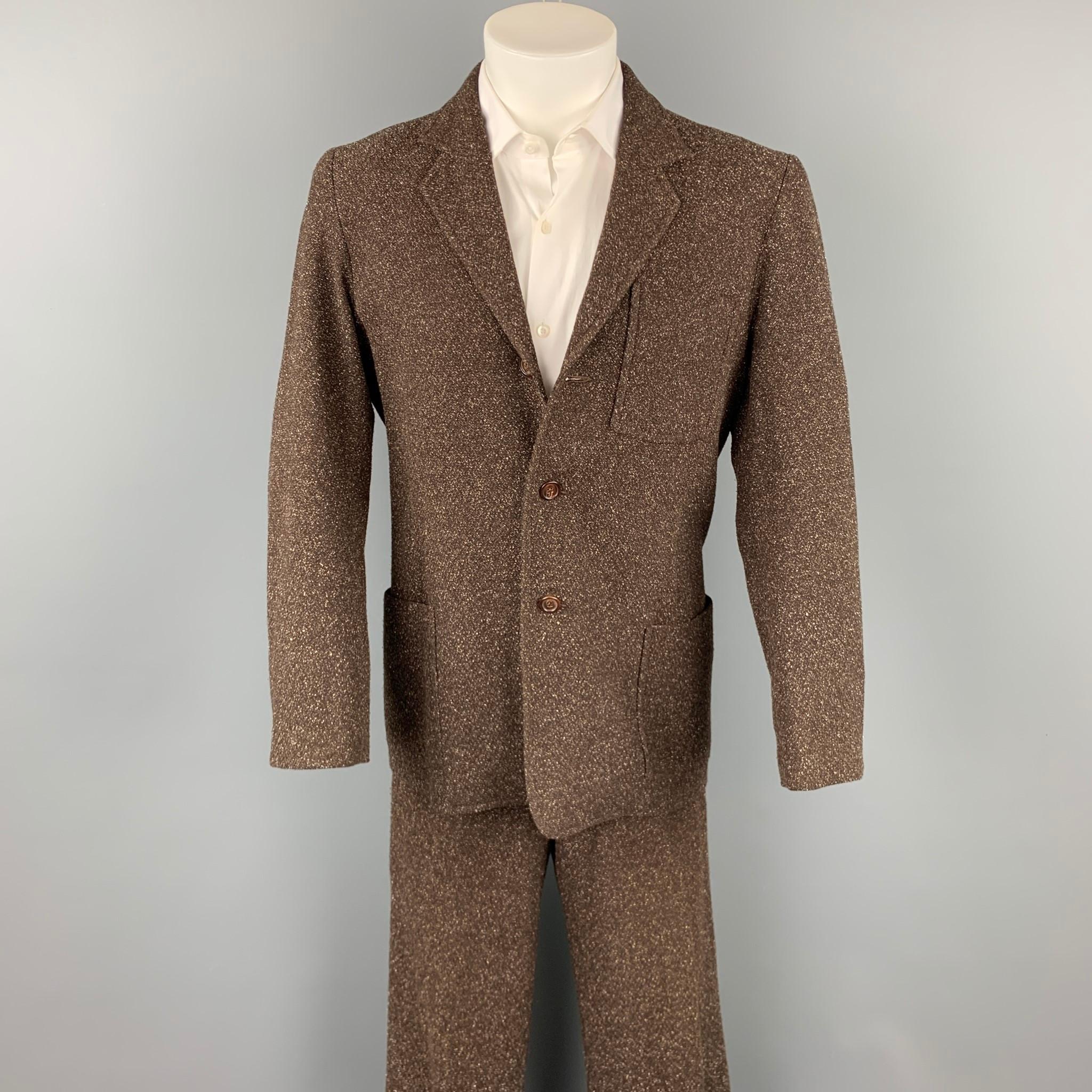 LAT NAYLOR suit comes in a brown heather polyester with a full liner and includes a single breasted, three button sport coat with a notch lapel and matching flat front trousers. Made in USA.

Very Good Pre-Owned Condition.
Marked: