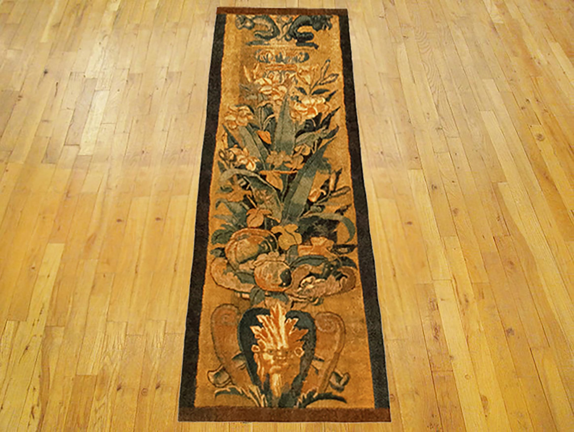 A 16th century Brussels Historical Tapestry panel. This vertically oriented decorative tapestry panel depicts a scrolling foliate design, with a grotesque and a coat of arms at bottom, and with the top of a Roman column at top. The central area is