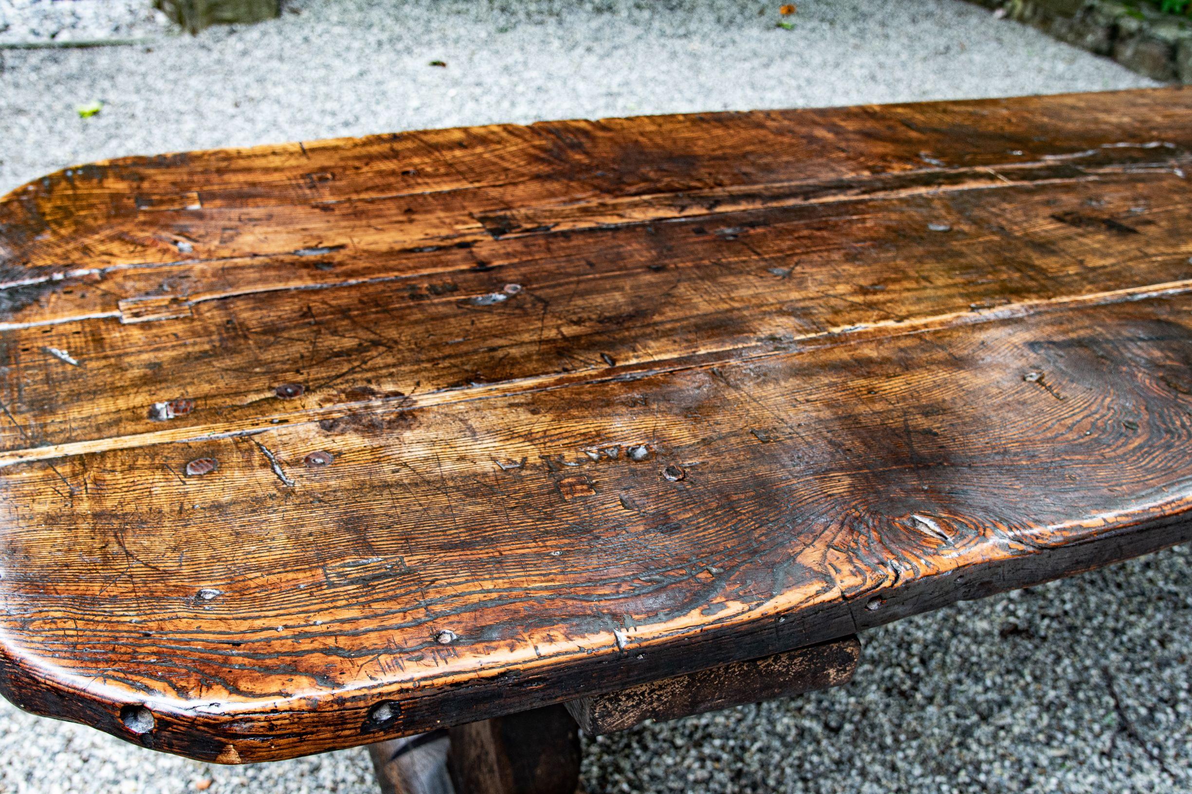 Fabulous late 16th century, possibly early 17th century Welsh oak refectory table. Absolutely superb color and patina. The long planked top sits over a single hidden stretcher on two sledge feet, circa 1590-1630. The table is well preserved, and