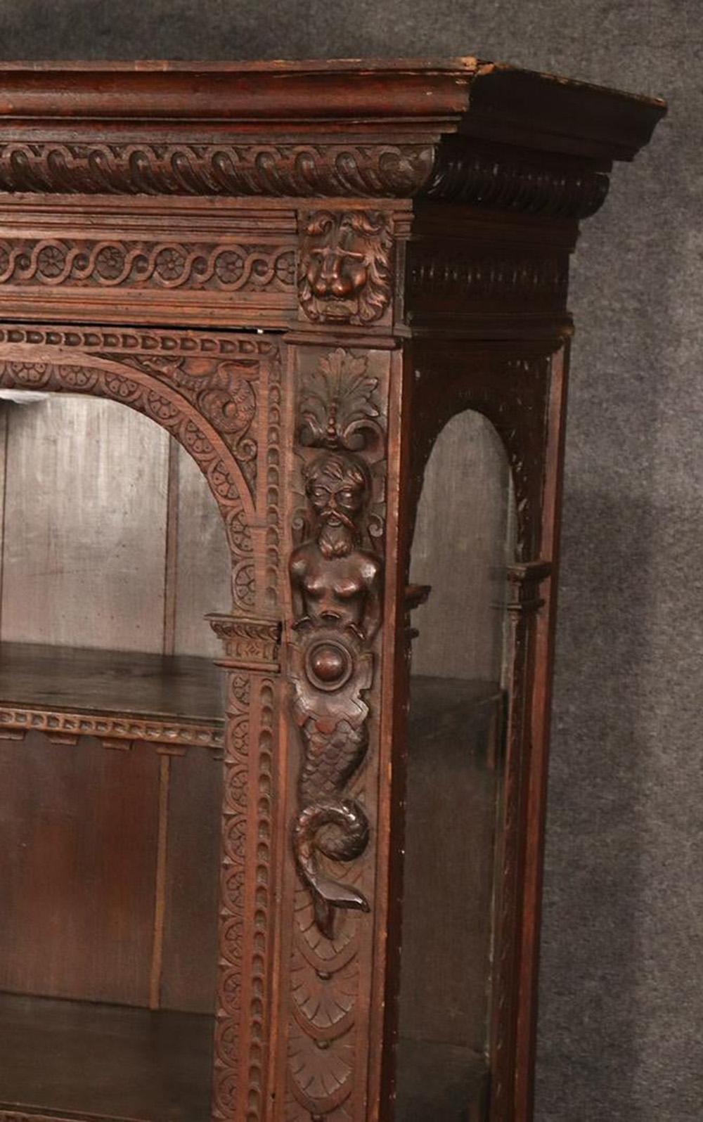 Rare late 1700s era Italian carved oak figural china cabinet vitrine bookcase with one door and 2 shelves.
Measures: 66 1/8
