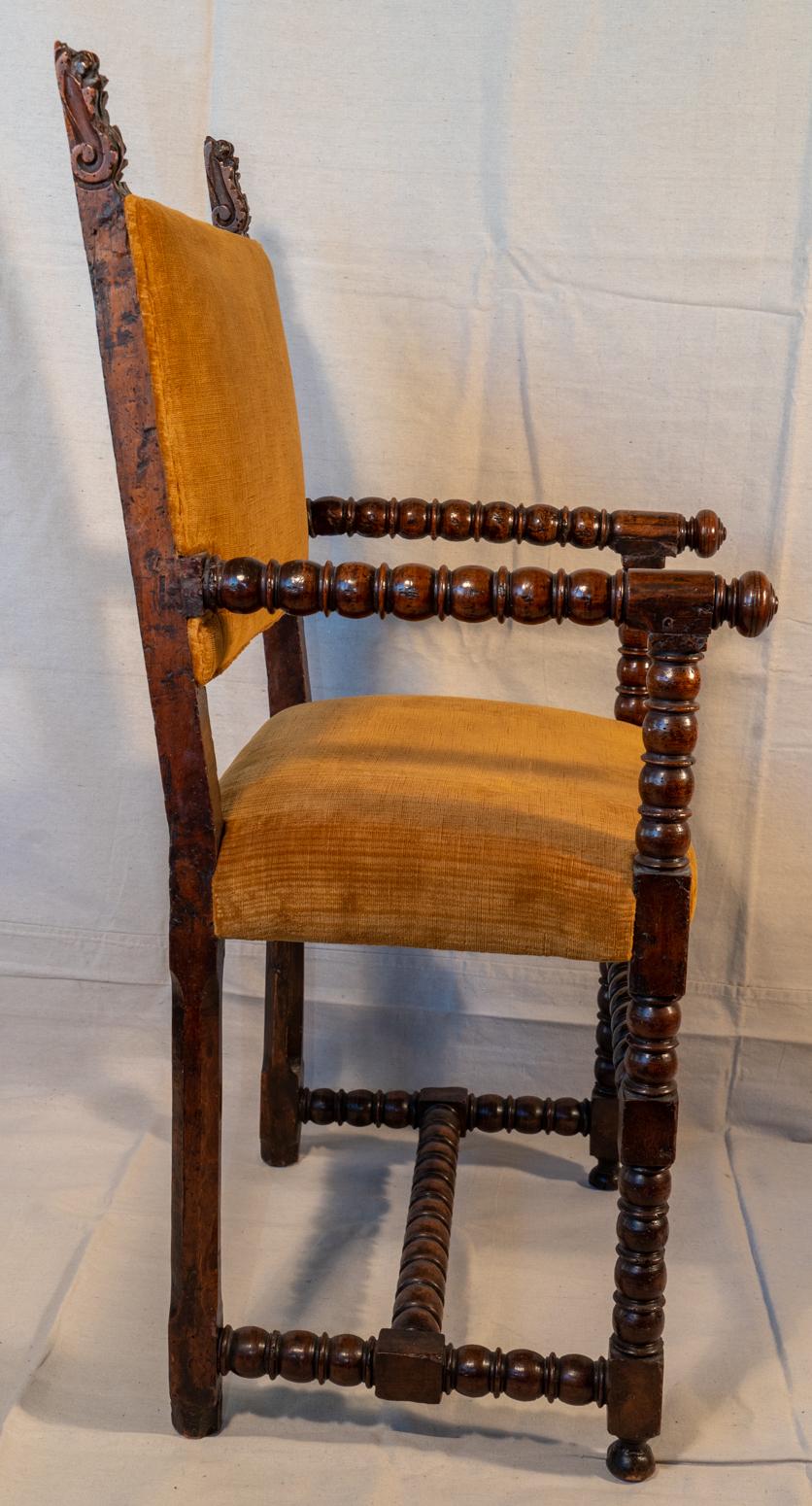 Late 17th century Italian walnut armchair
Classic Italian hall chair with bobbin turned arms, front legs and stretchers.
Very nice plush amber colored velvet upholstery (older re-cover) in very good condition. Tops of the back legs with carved