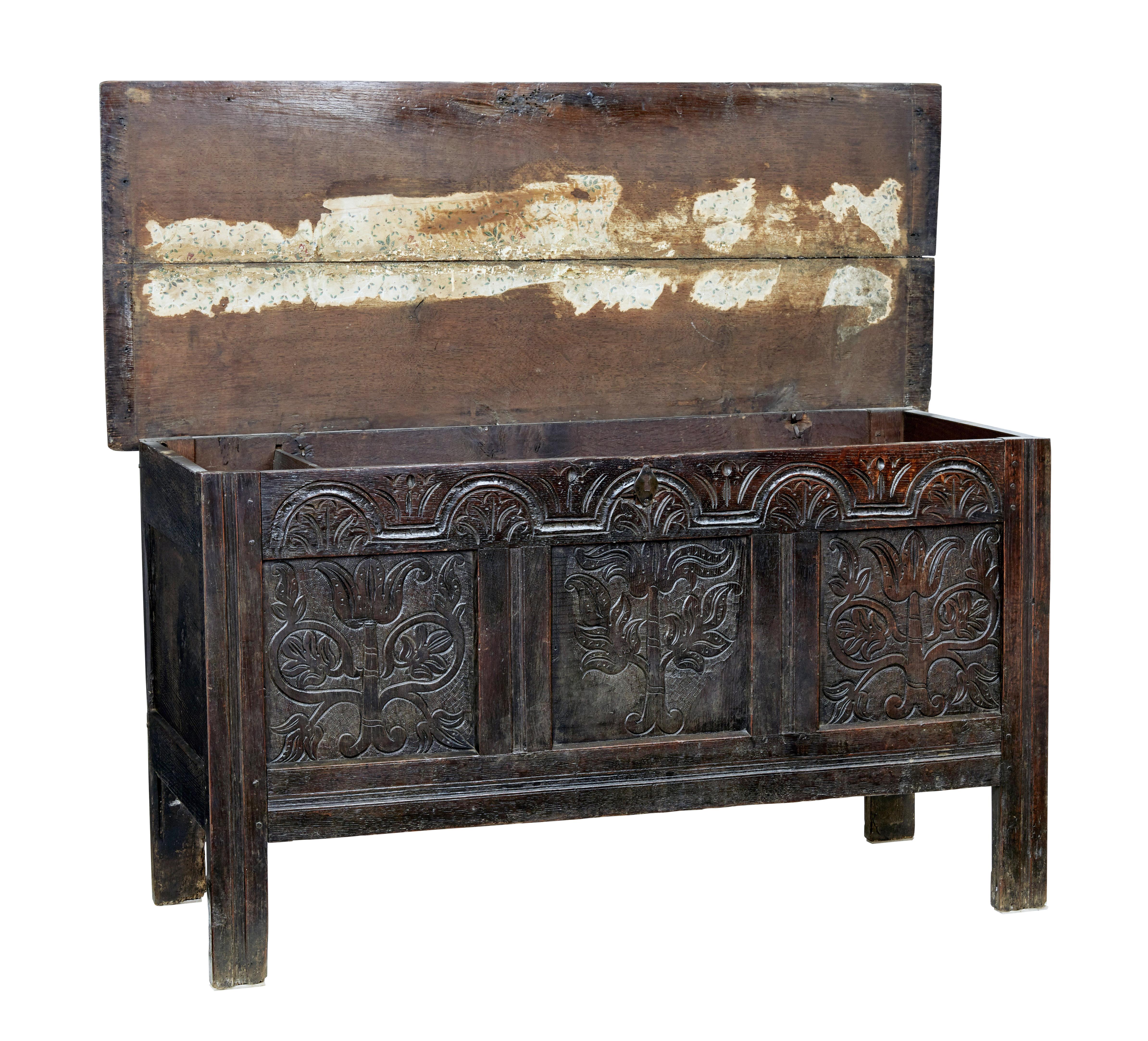 Late 17th century carved oak coffer circa 1680.

Good quality coffer of large proportions. Carved panelled front with florals and arches. Standing on plank legs, still maintaining their original length.

2 plank top with original hinges. Lid