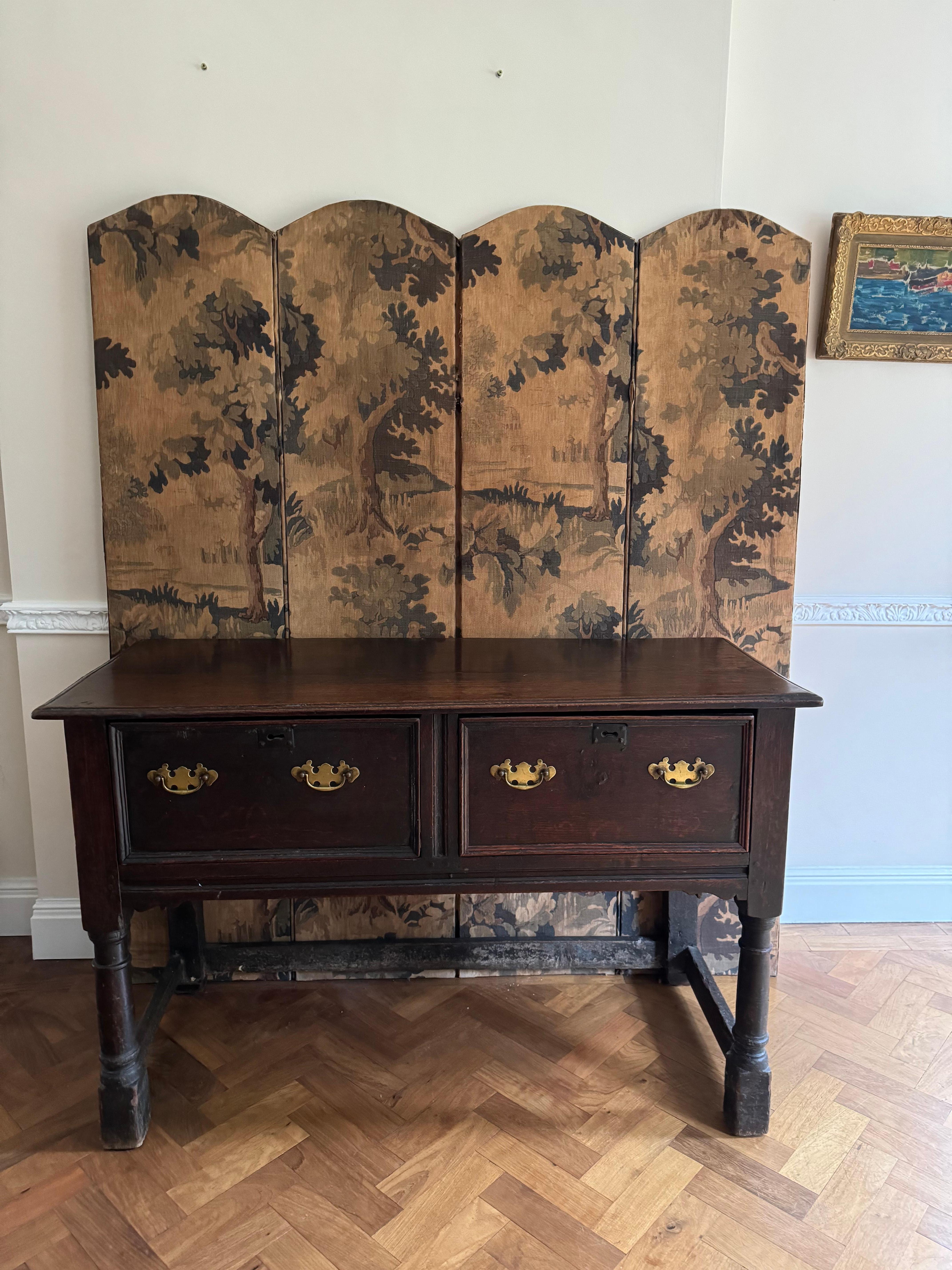 A well patinated and used late 17th century dresser or base table c.1680 incorporating earlier reused pieces. Side hung drawers are often seen on Jacobean or William IV furniture  
As can be visibly seen from the photos, the dresser has been