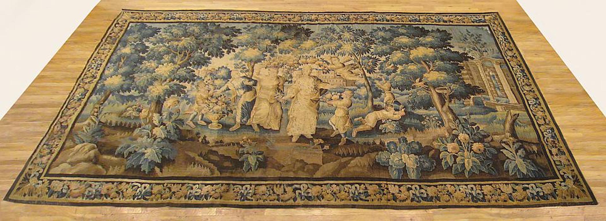 A French Aubusson “Louis XIV” allegorical tapestry from the late 17th or early 18th century, depicting an allegory of Spring, with Flora crowned by Zephyr, surrounded by other mythological figures and children in a lush verdant landscape. This