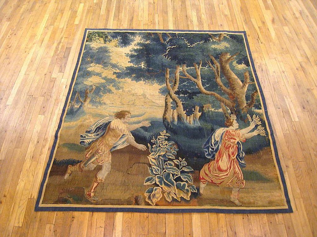A French Aubusson mythological tapestry from the late 17th century, envisioning the Greek deity Apollo chasing the beauteous Daphne. Daphne, the daughter of a river god, was famed for her beauty, but rejected all lovers, choosing instead a chaste,