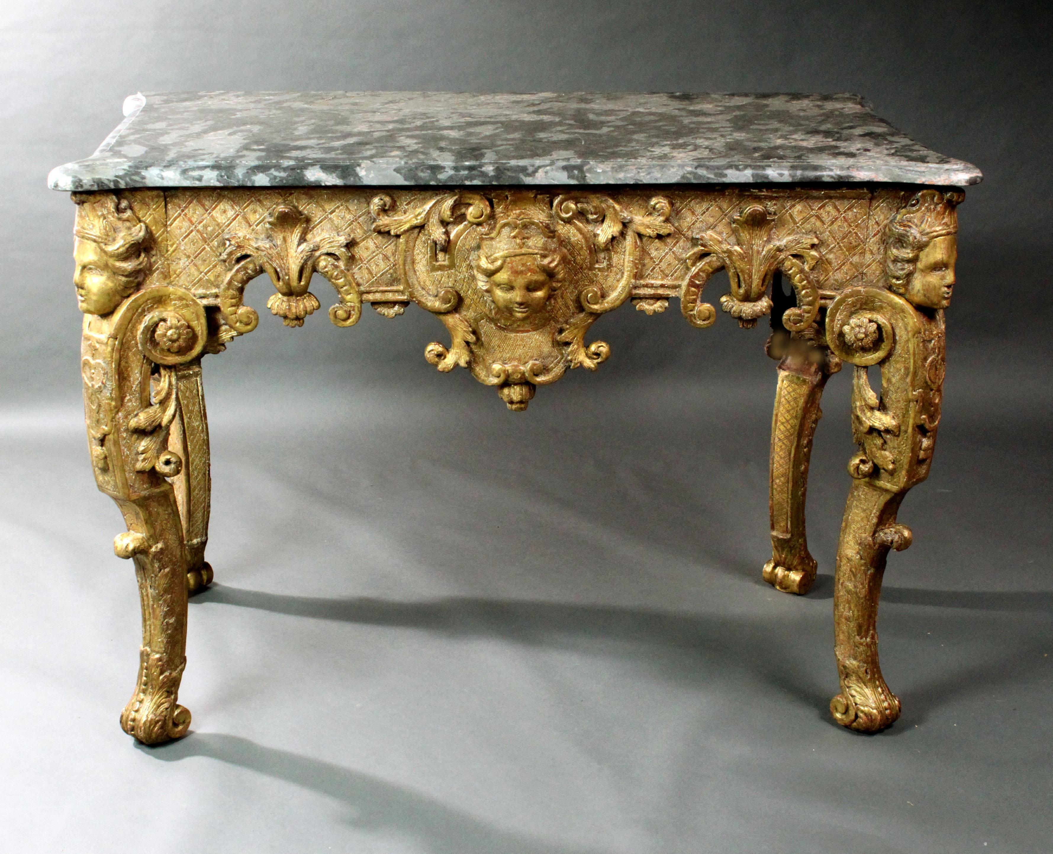 A fine late 17th-early 18th century Italian or French giltwood console table retaining much of its original gilding; supported on well carved caryatids with scroll feet; the frieze with carved acanthus leaves, Rococo scrolls and a carved mask on a