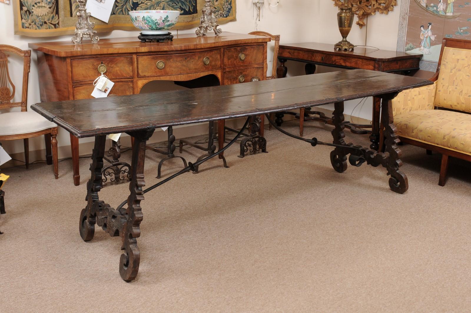 A late 17th century Italian hall table in chestnut with lyre legs and iron stretcher.