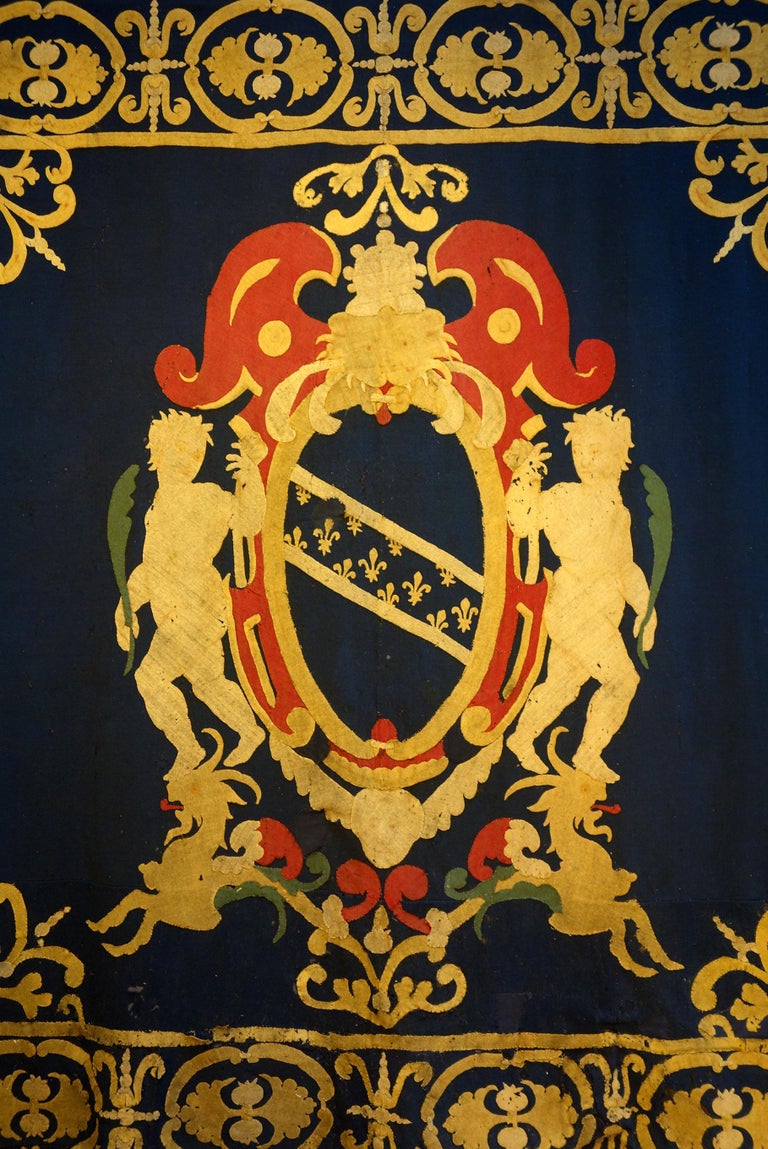 Aristocratic style is presented by this tapestry, a heraldic coat of arms formed by woolen cloth of different colors applied in collage on blue woolen cloth. Lucchese (Lucca) manufacture of the late 17th century, circa 1690. The central shield