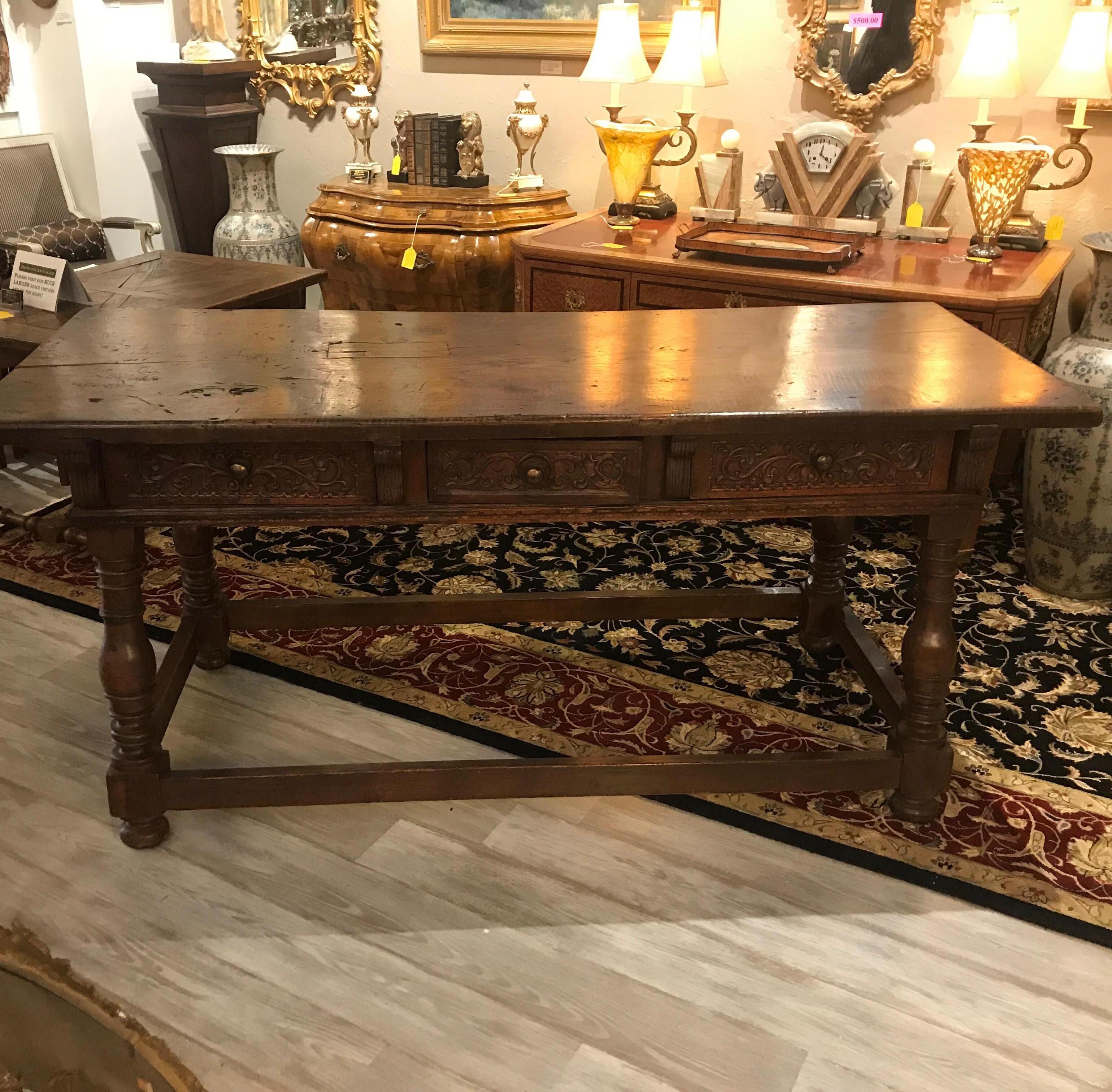 Remarkable late 17th century Italian pub or wine tasting table with three hand carved drawers. The finish has been French polished but still preserves the centuries of use and wear that makes this table truly one of a kind. There are old repairs and
