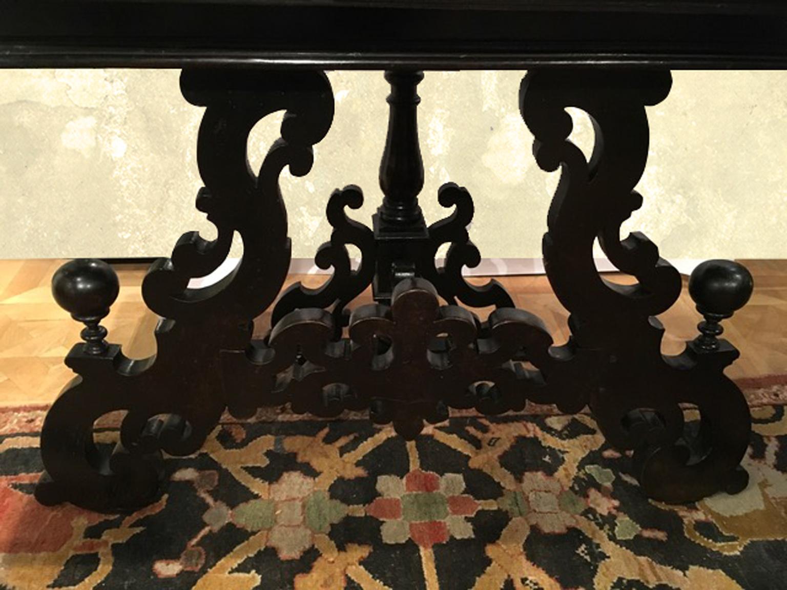 This antique black ebony wood console, is an example of the fine quality and capability in handcrafting of the Italian 17th Century masters. The top is in a rare black Italian marble coming from Lombardia Mountains. The country of origin of this
