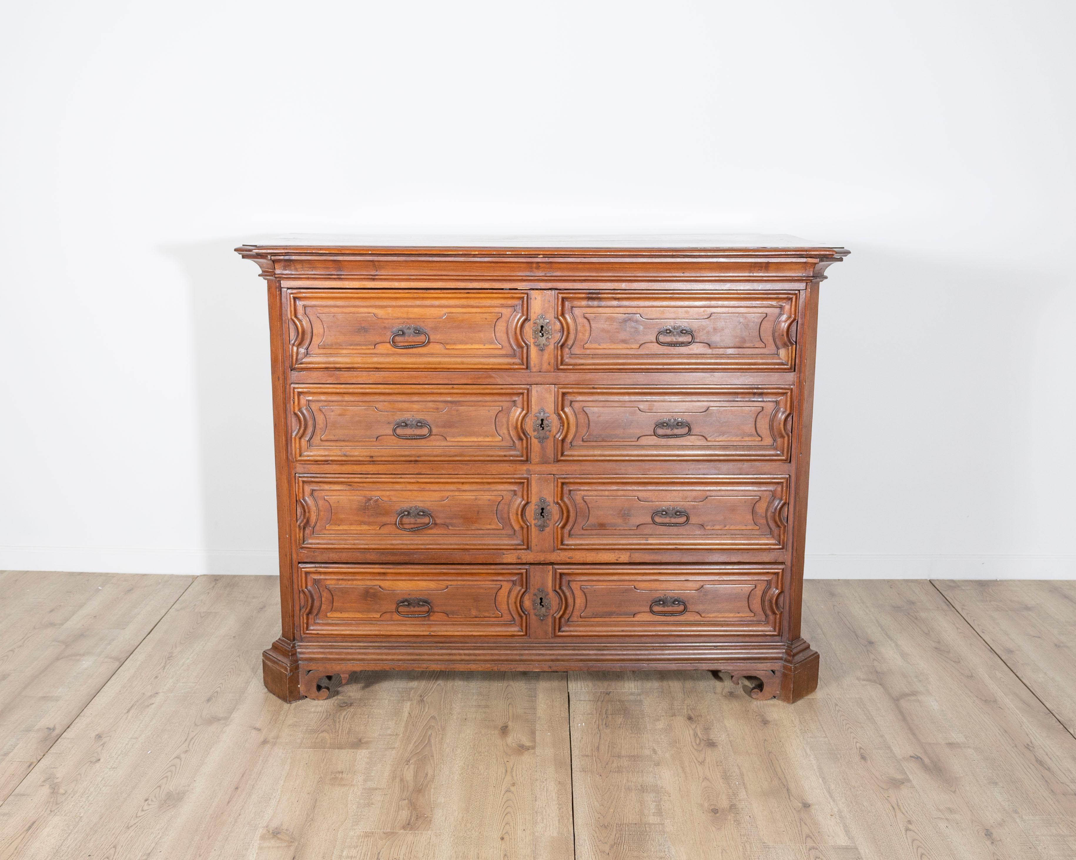 An exceptional Lombard chest of drawers, or canterano, from the Brescia region, dating to the full 1600s. Crafted entirely from solid walnut, this imposing piece is a rare example of northern Italian baroque cabinetry that combines both