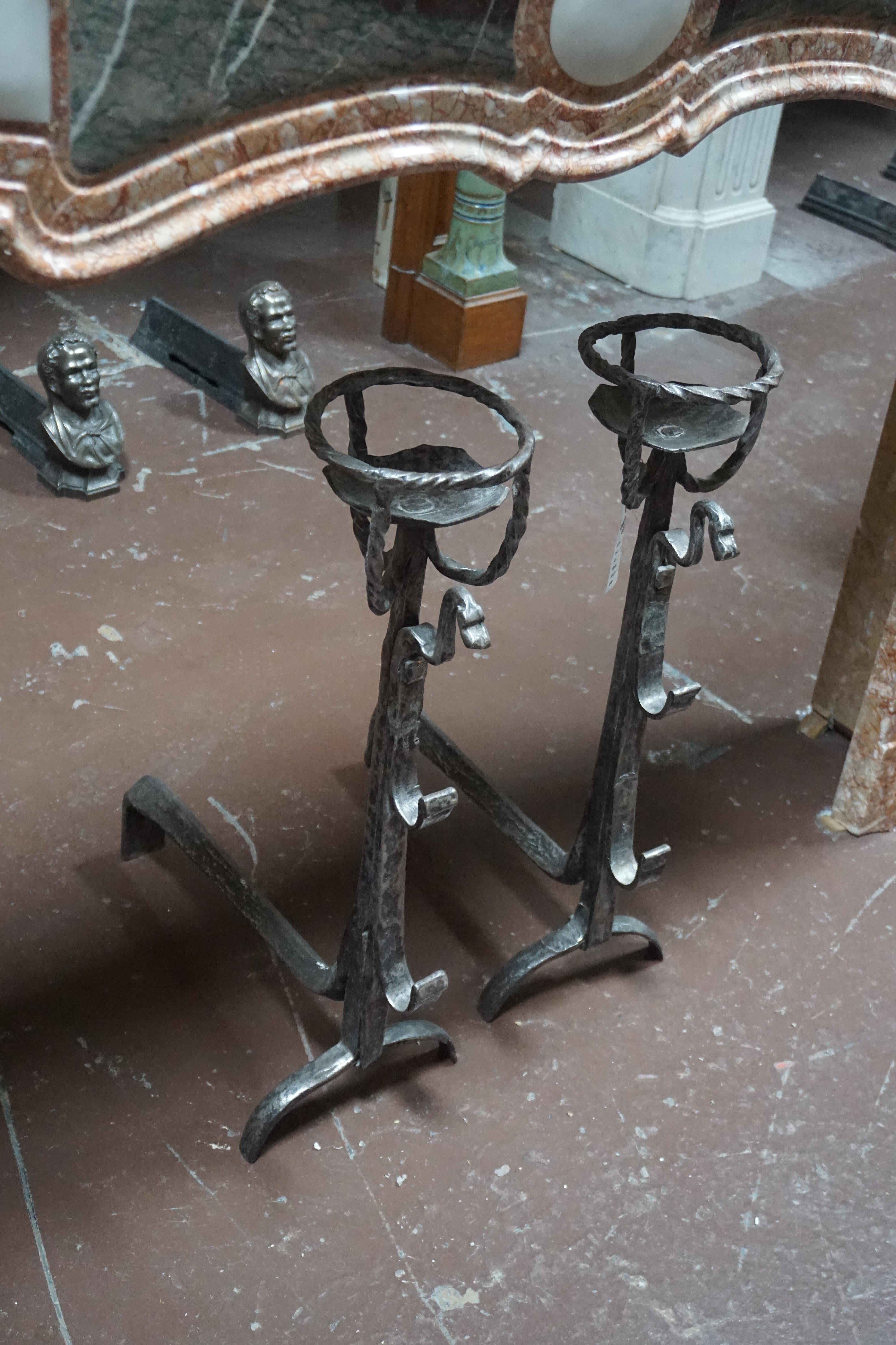 These each feature an adjustable vessel holder atop a tapering ringed standard, having lower and middle outset skewer hooks, ending with bifurcated arched feet. They have a recent polish for an extraordinary patina. These are probably of French