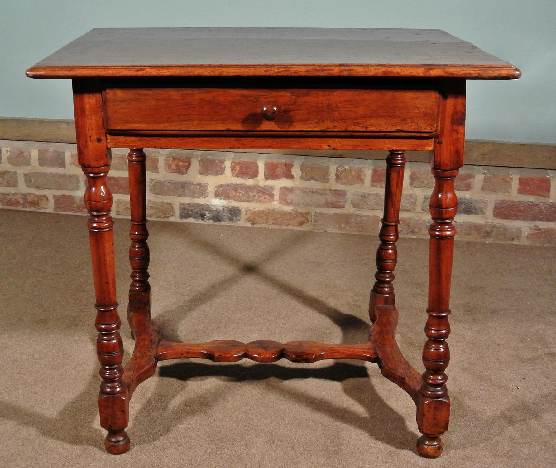 With a superb color, a late 17th century walnut tavern table in very good original condition. 

The over-sailing top made from a single thick plank of walnut with stepped and bullnosed border to all four sides. The stepped and bullnosed detail