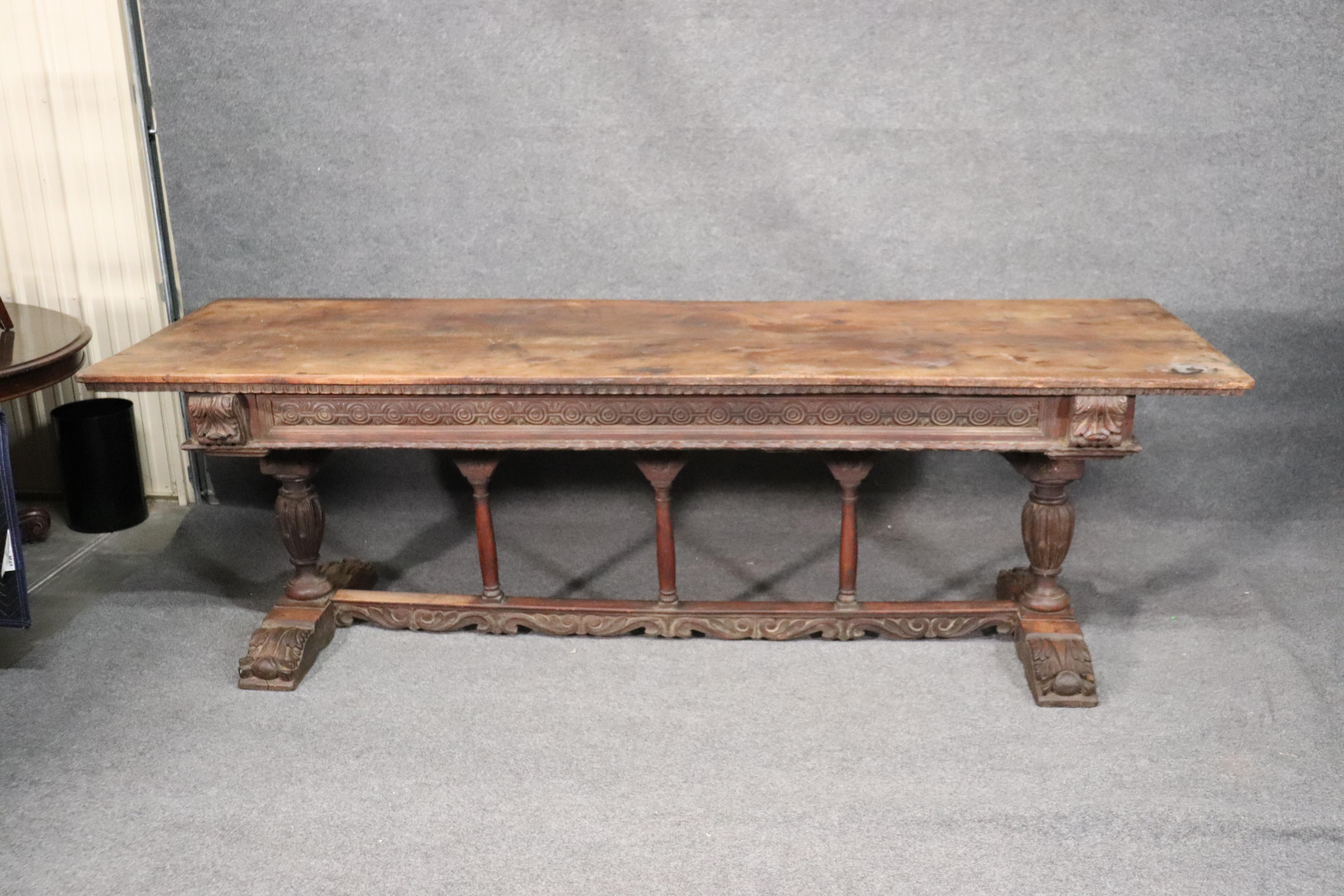 This is a rare solid walnut Italian Baroque dining or library dining table. The table has a removable top and drawers which is not common for a table of this length. The table is in as-found condition and has the usual tell-tale signs of age and