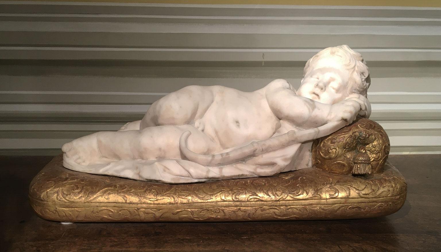 Baroque Late 17th Century White Marble Carved Child Nude Cupid Sculpture on Gilded Base For Sale
